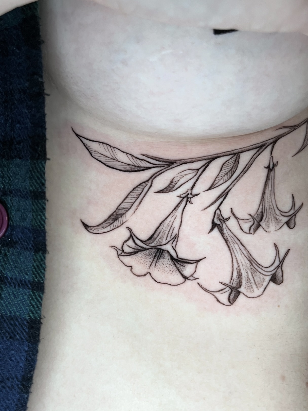 Bell flowers black and grey tattoo on the chest by Samantha