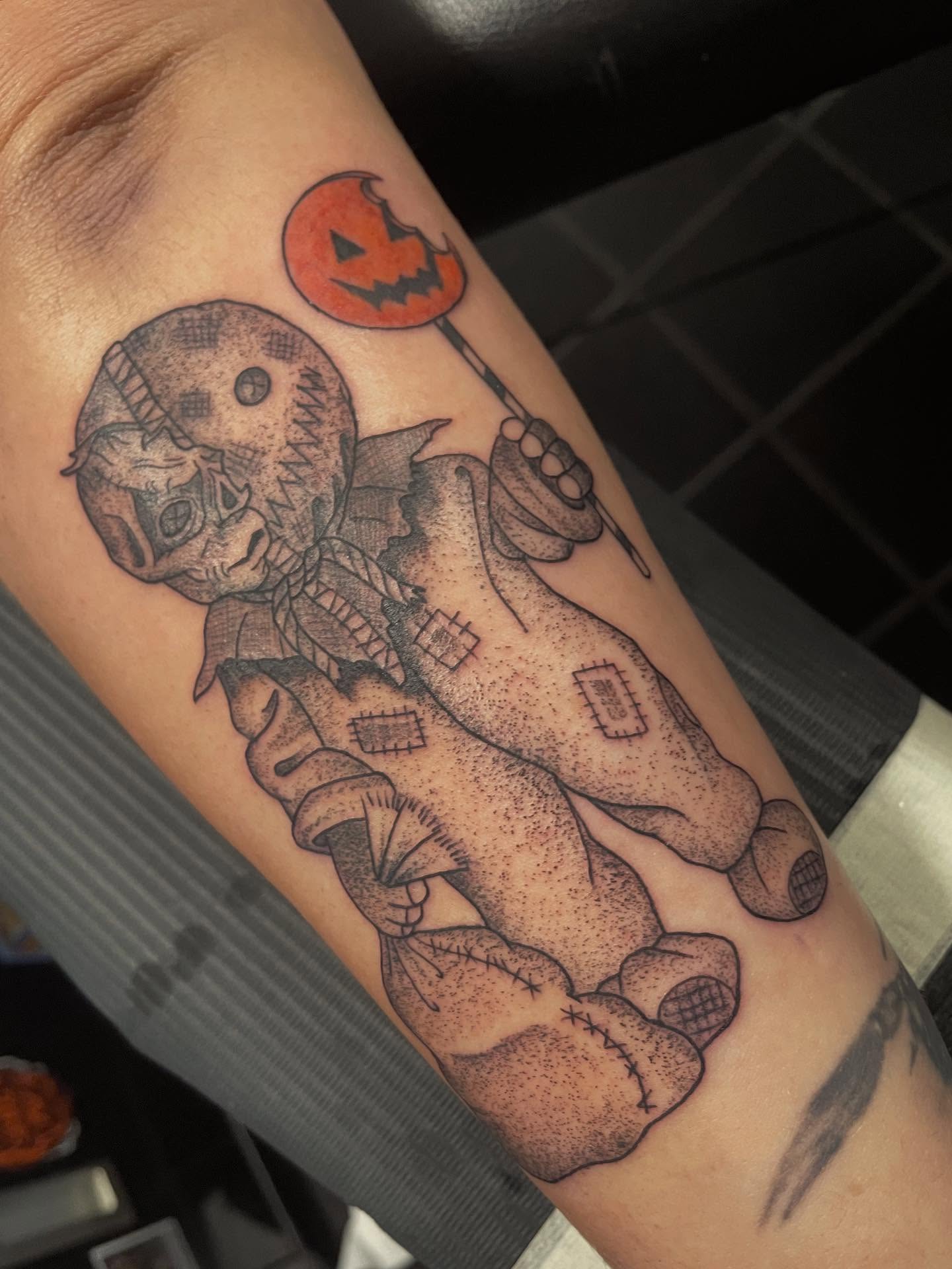 Stuffed doll with pumpkin dotwork tattoo on the forearm by Andres Patino 🇪🇨🇺🇸