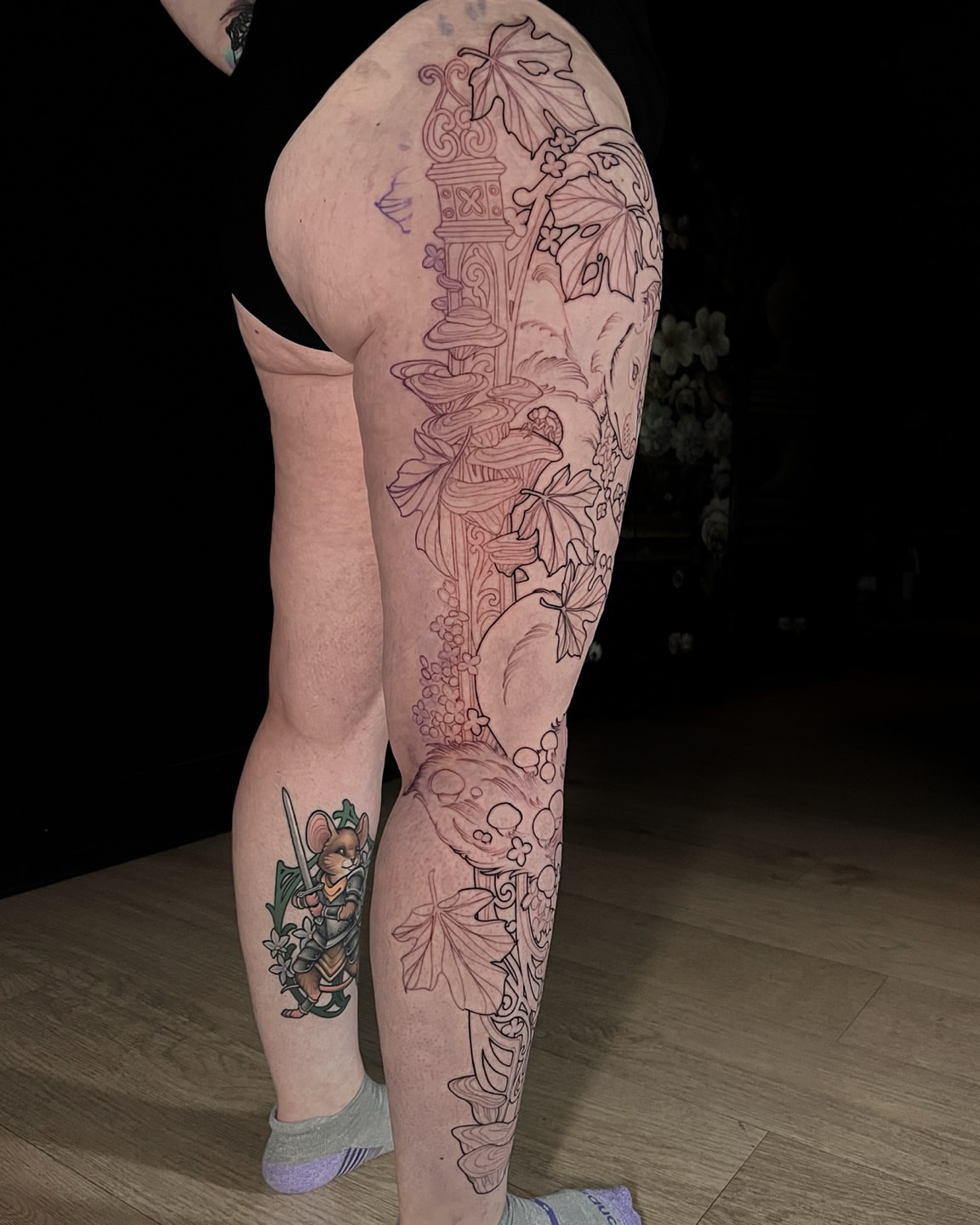 Autumn leaves and pumpkin black and grey tattoo on the thigh by Hannah Steele