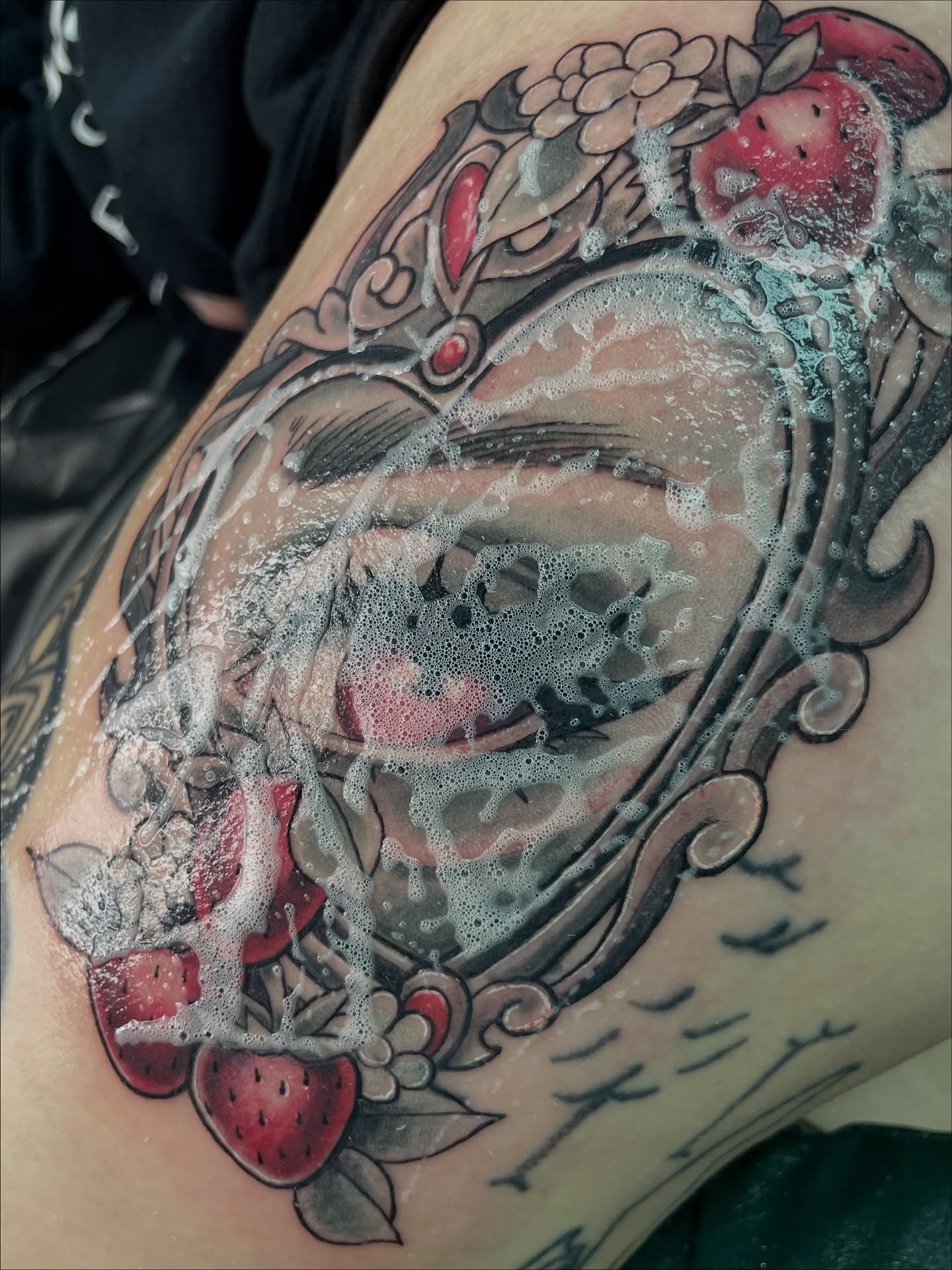 Strawberry and floral American traditional tattoo on the thigh by 𝑲𝒂𝒊𝒕 𝑨𝒏𝒅𝒆𝒓𝒔𝒆𝒏