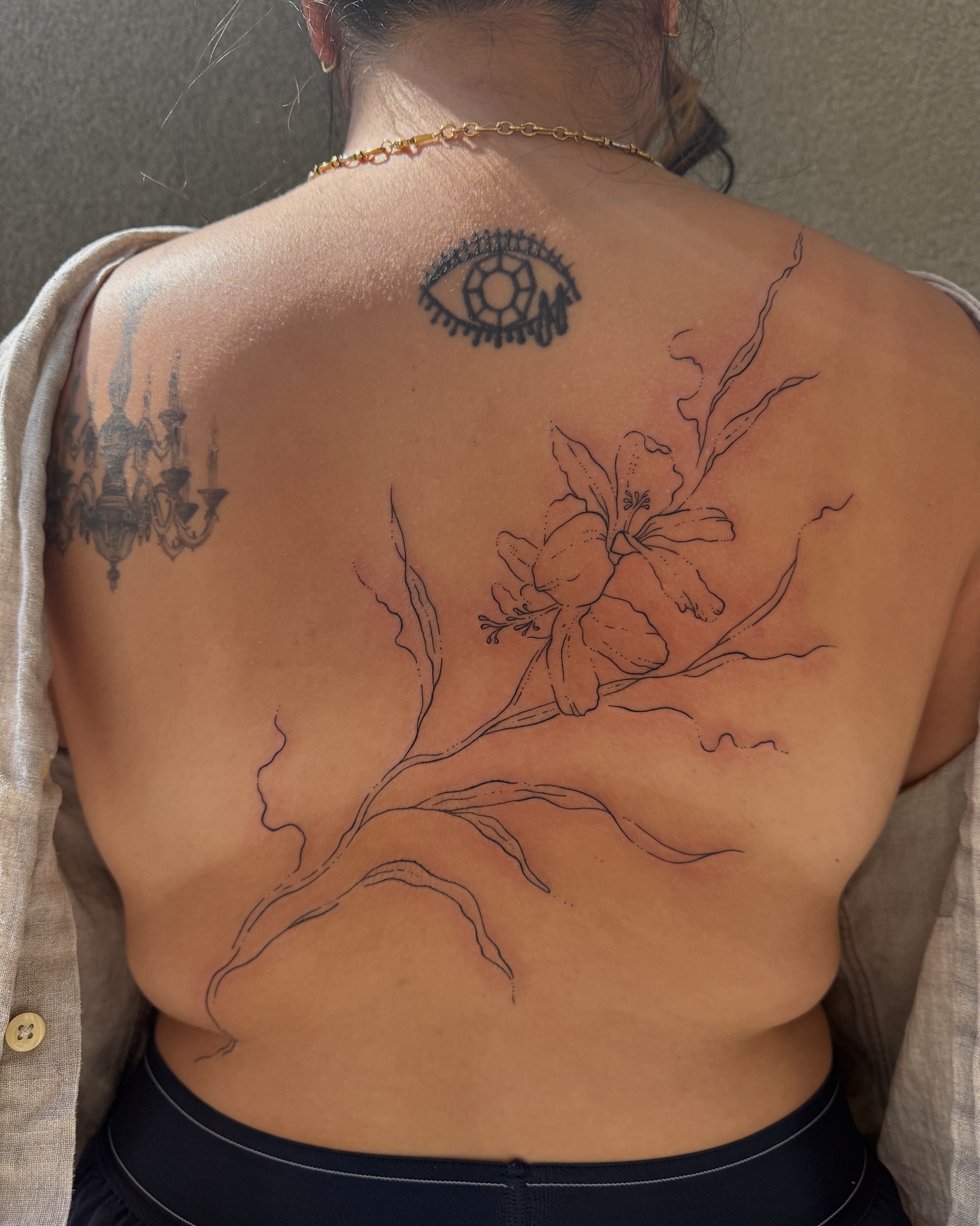 Flower branch black and grey tattoo on the back by Inky Apricot, Austin, Texas