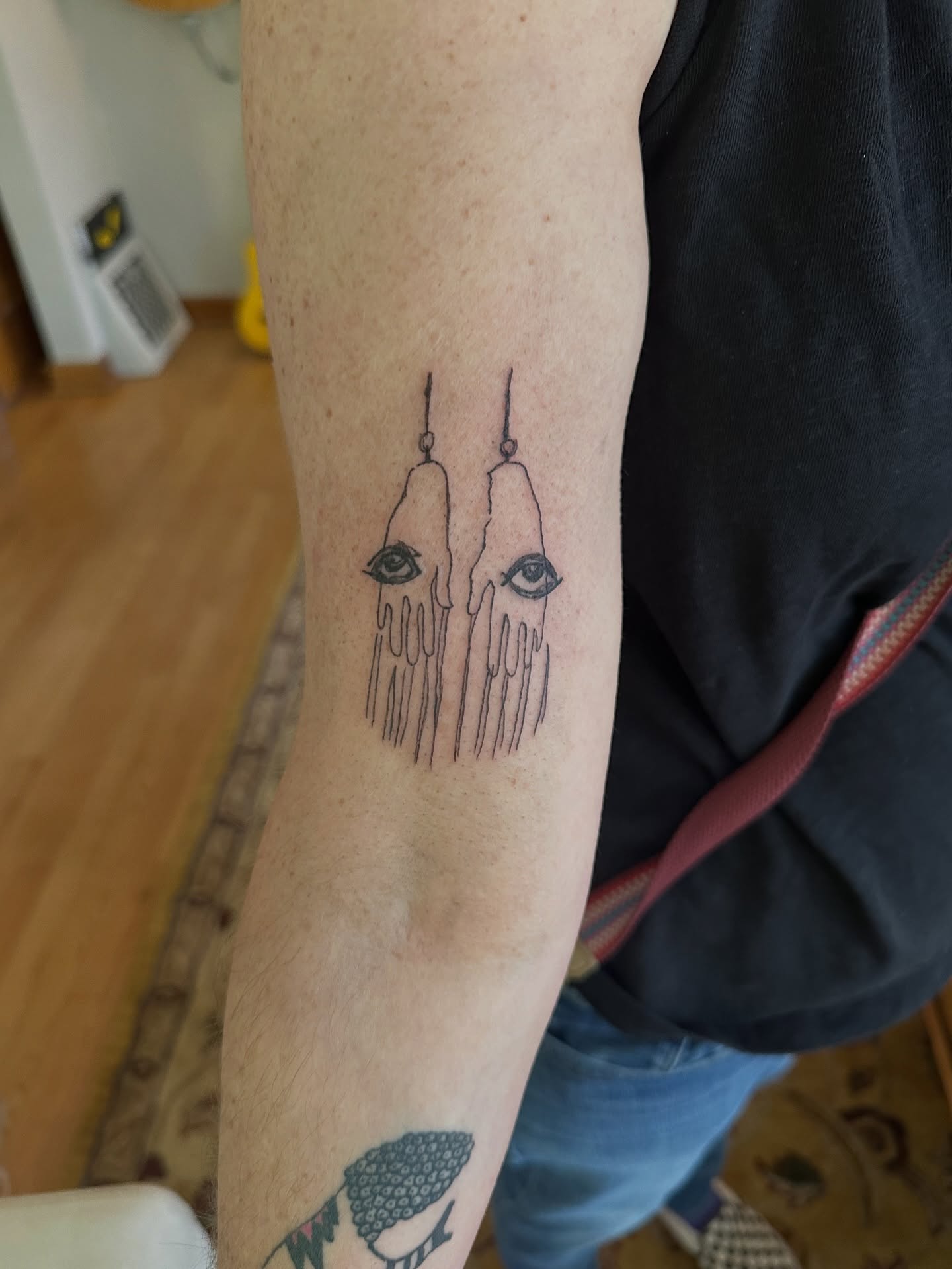 Tears and eyes minimalist tattoo on the forearm by Matt Tripodi