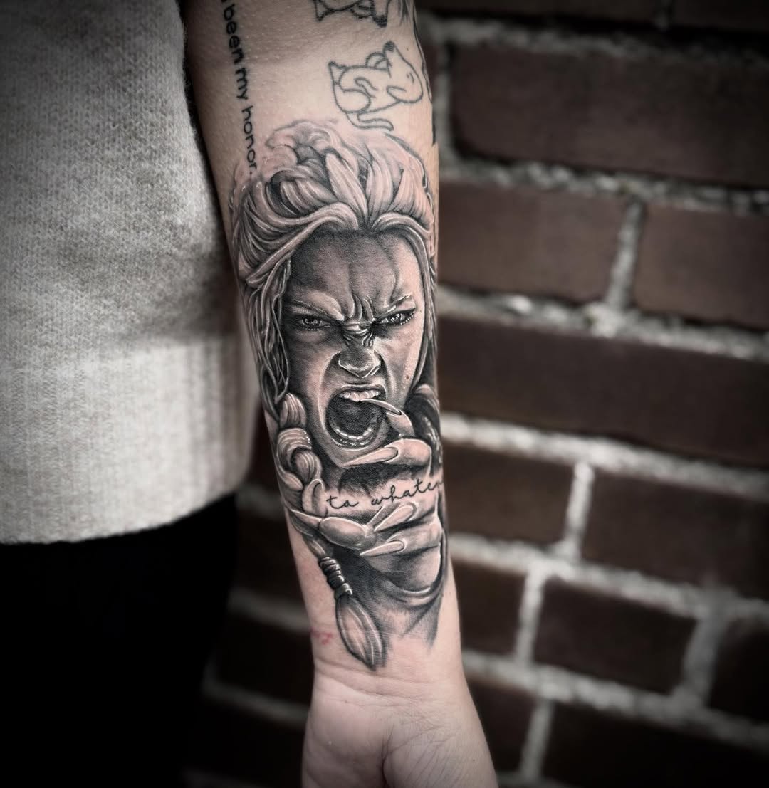 Screaming woman with claws realism tattoo on the forearm by Blake Van Vleck