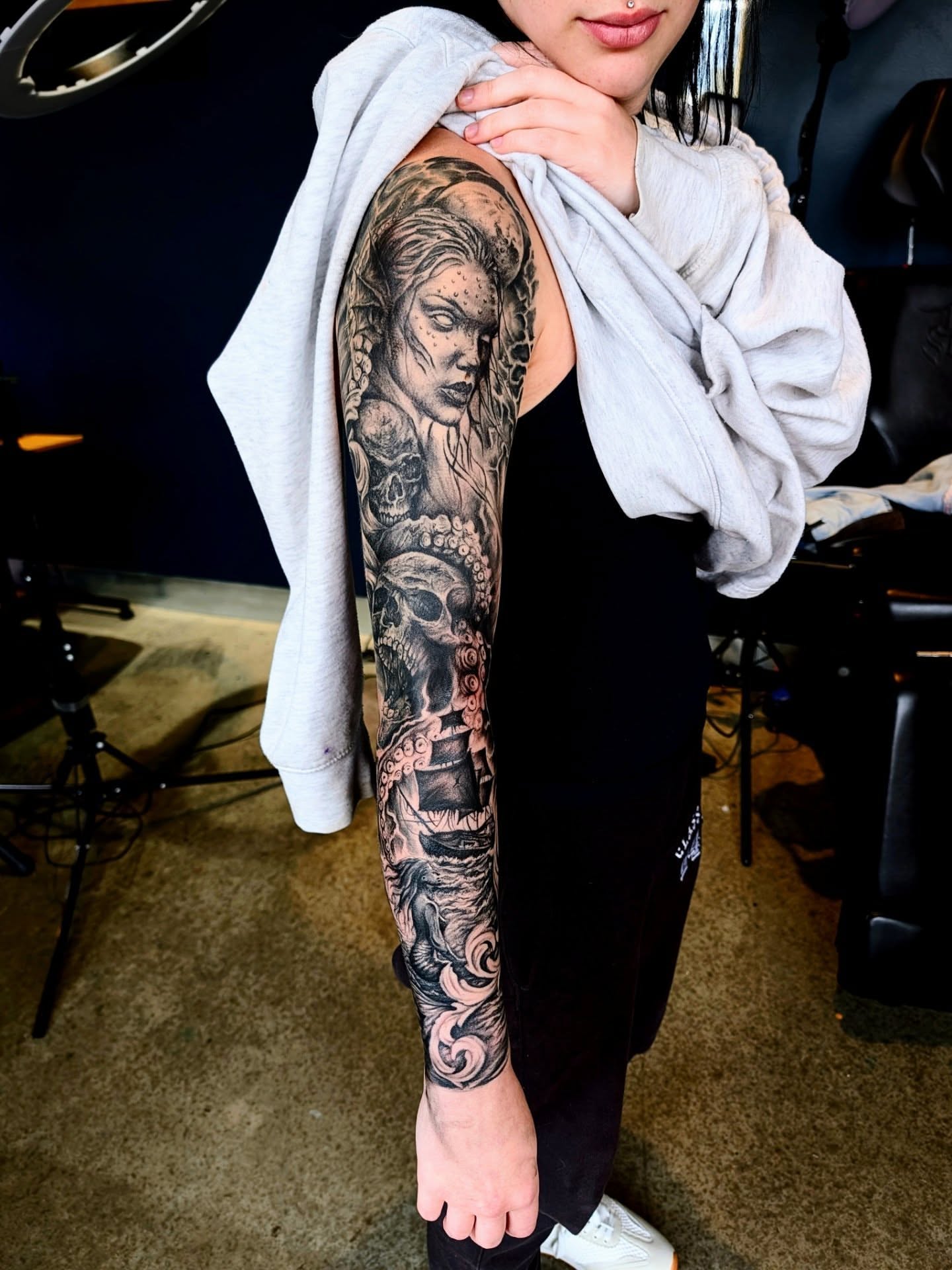 Woman with skull realism tattoo on the forearm by Drew King