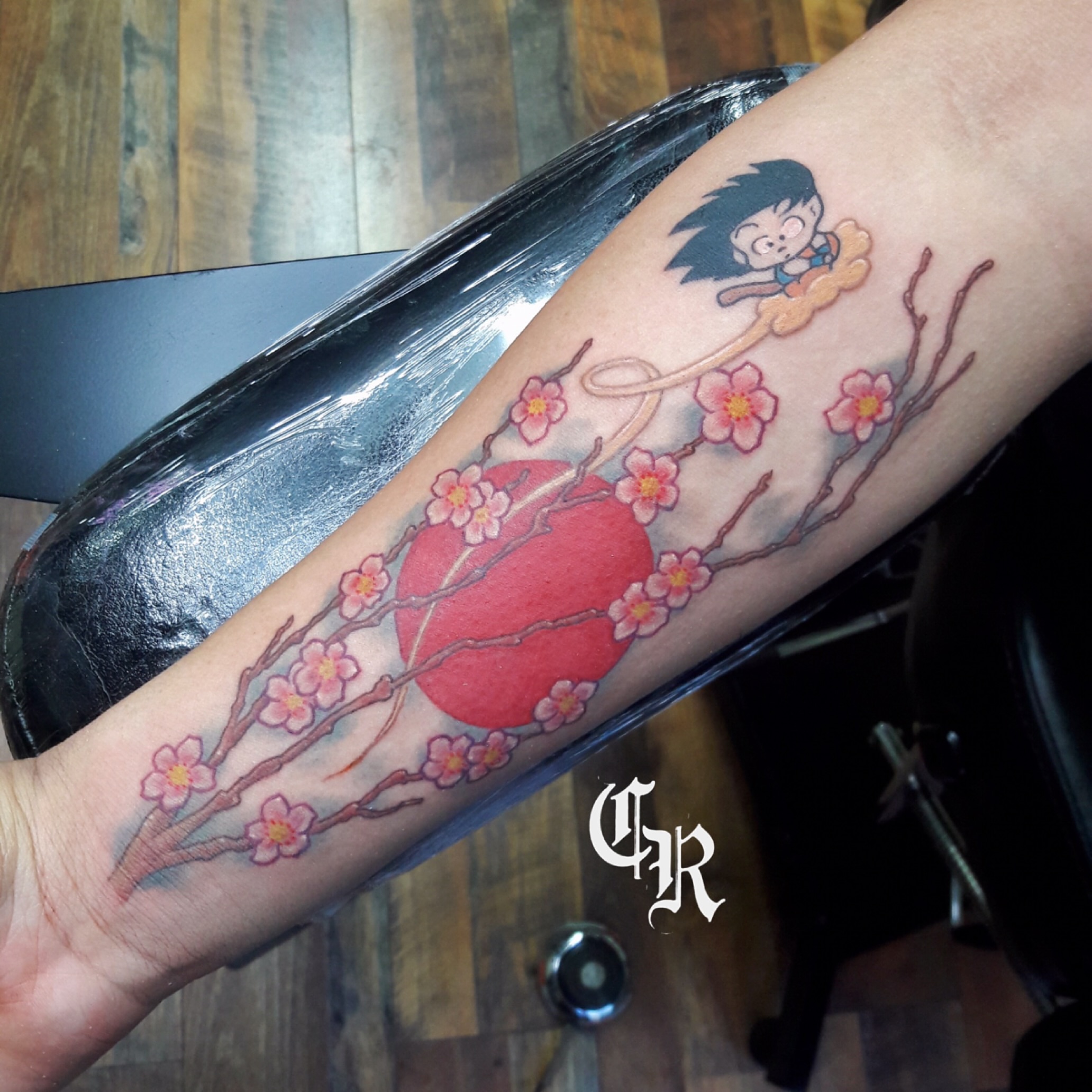 Cherry blossoms and sun japanese irezumi tattoo on the forearm by San Diego Tattoo Artist