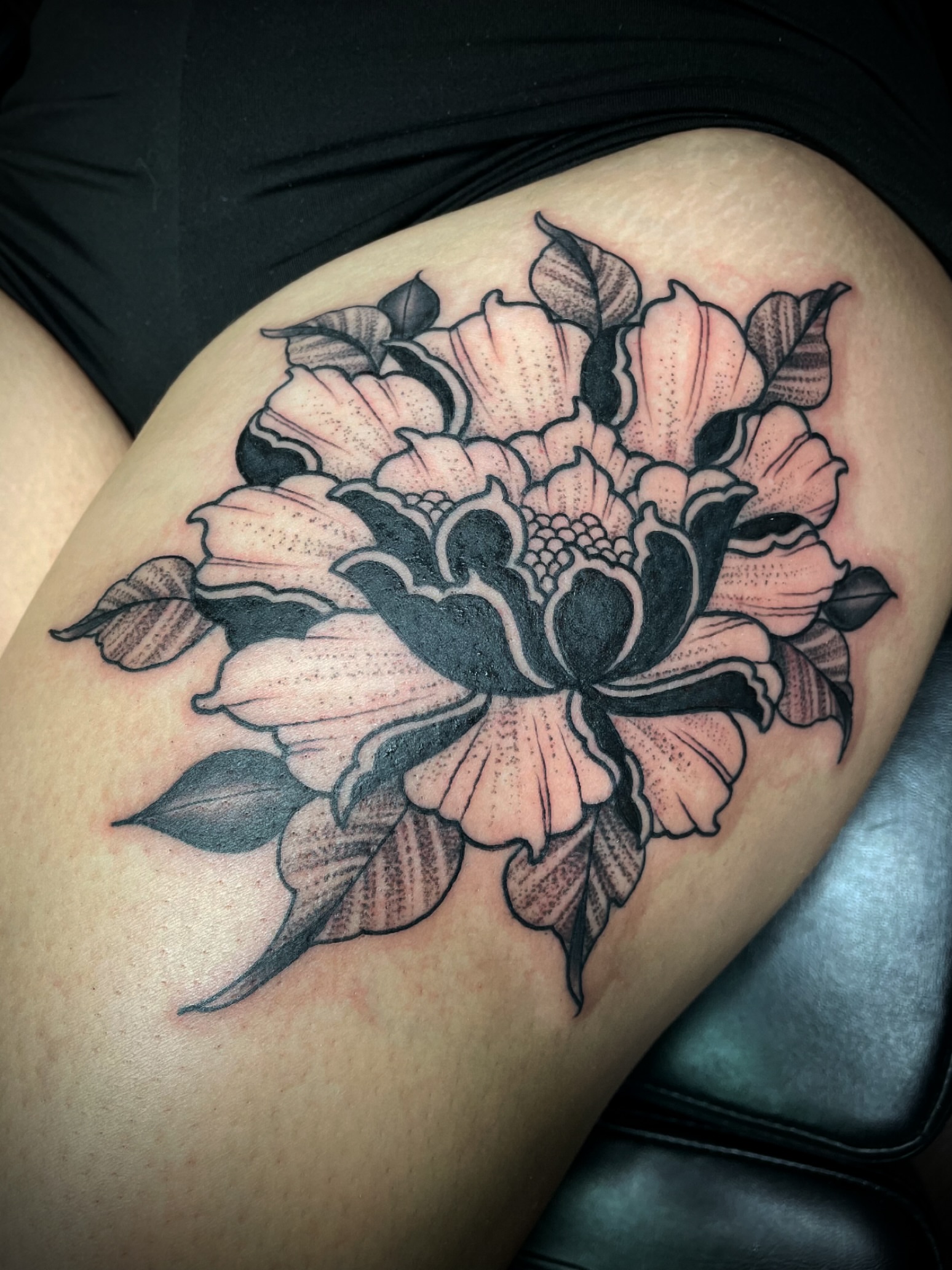 Peony black and grey tattoo on the thigh by San Diego Tattoo Artist