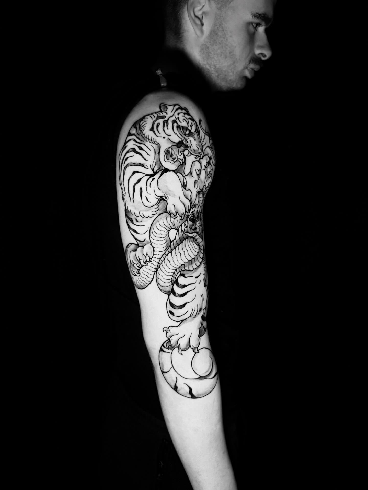 Tiger and snake Japanese tattoo on the forearm by Skunk Punk