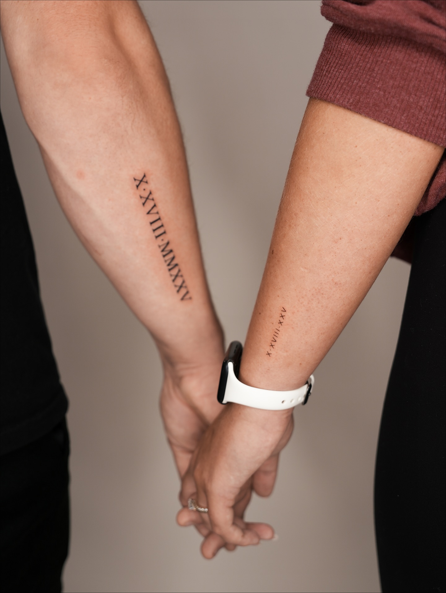 Roman numerals black and grey tattoo on the forearm by Lauren