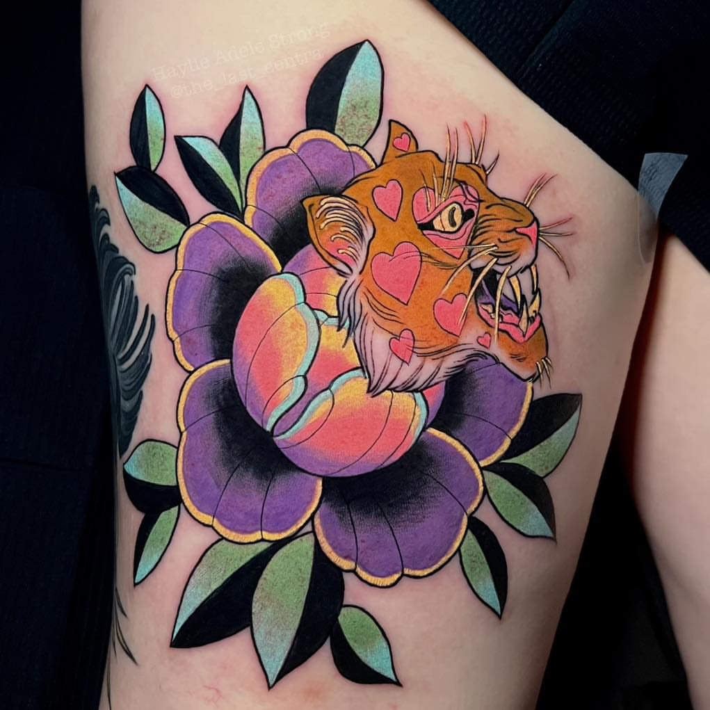 Tiger and flower American traditional tattoo on the thigh by Haylie Adele Strong