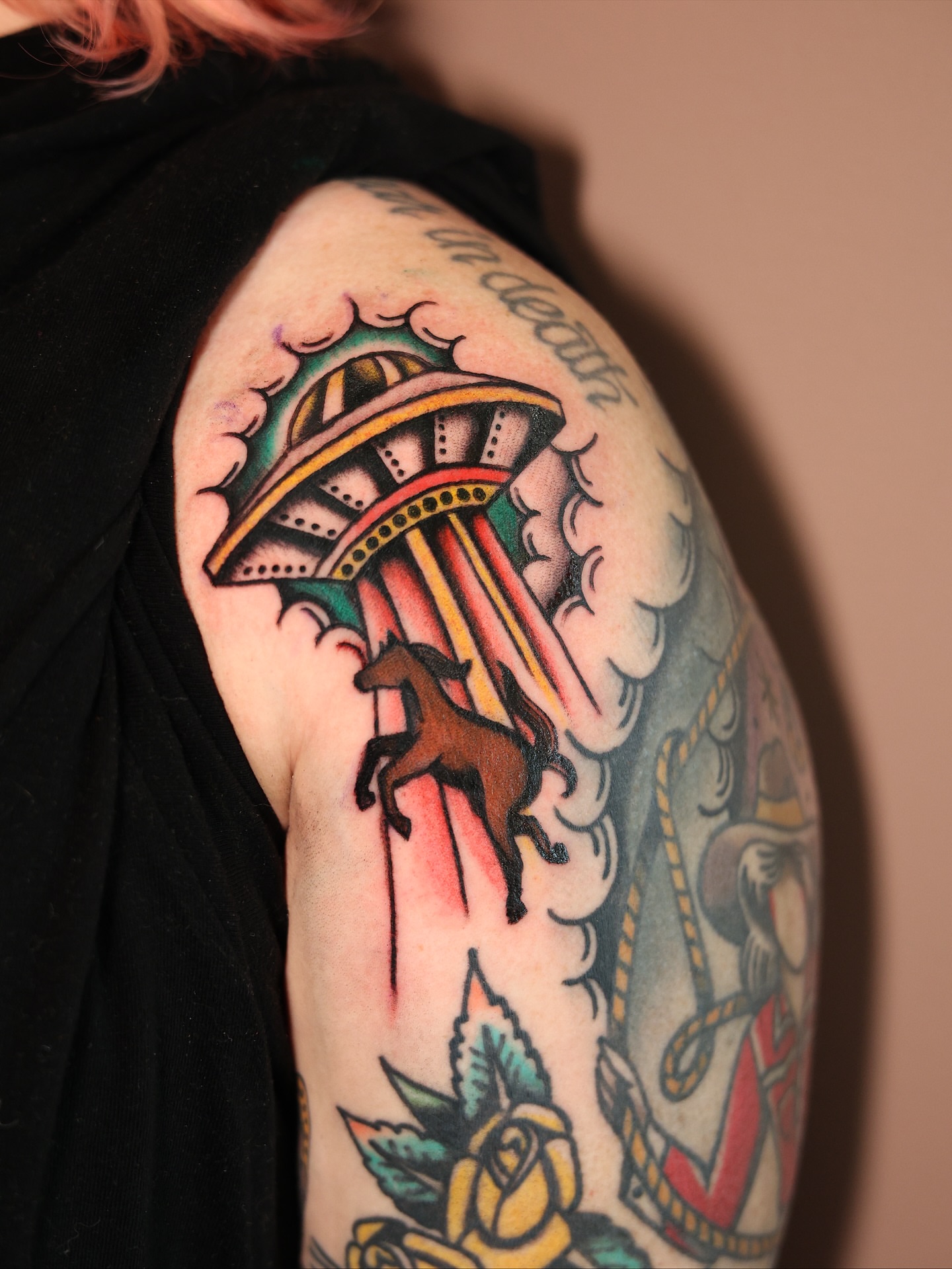 Horse and UFO American traditional tattoo on the upper arm by Dylan Mott