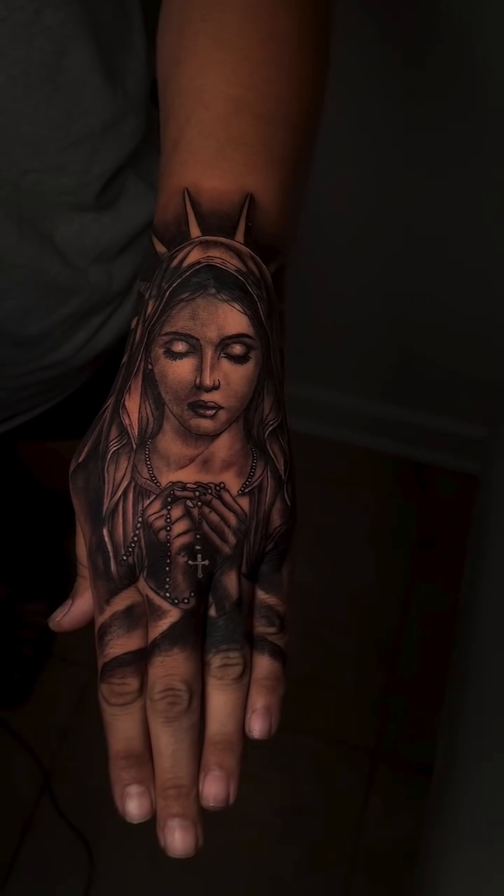Virgin Mary on hand realism tattoo by Thomas