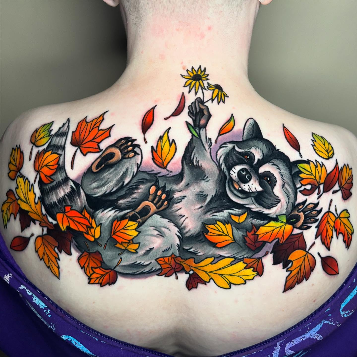 Raccoon and autumn leaves American traditional tattoo on the back by Chelsey Moore, Albuquerque, New Mexico
