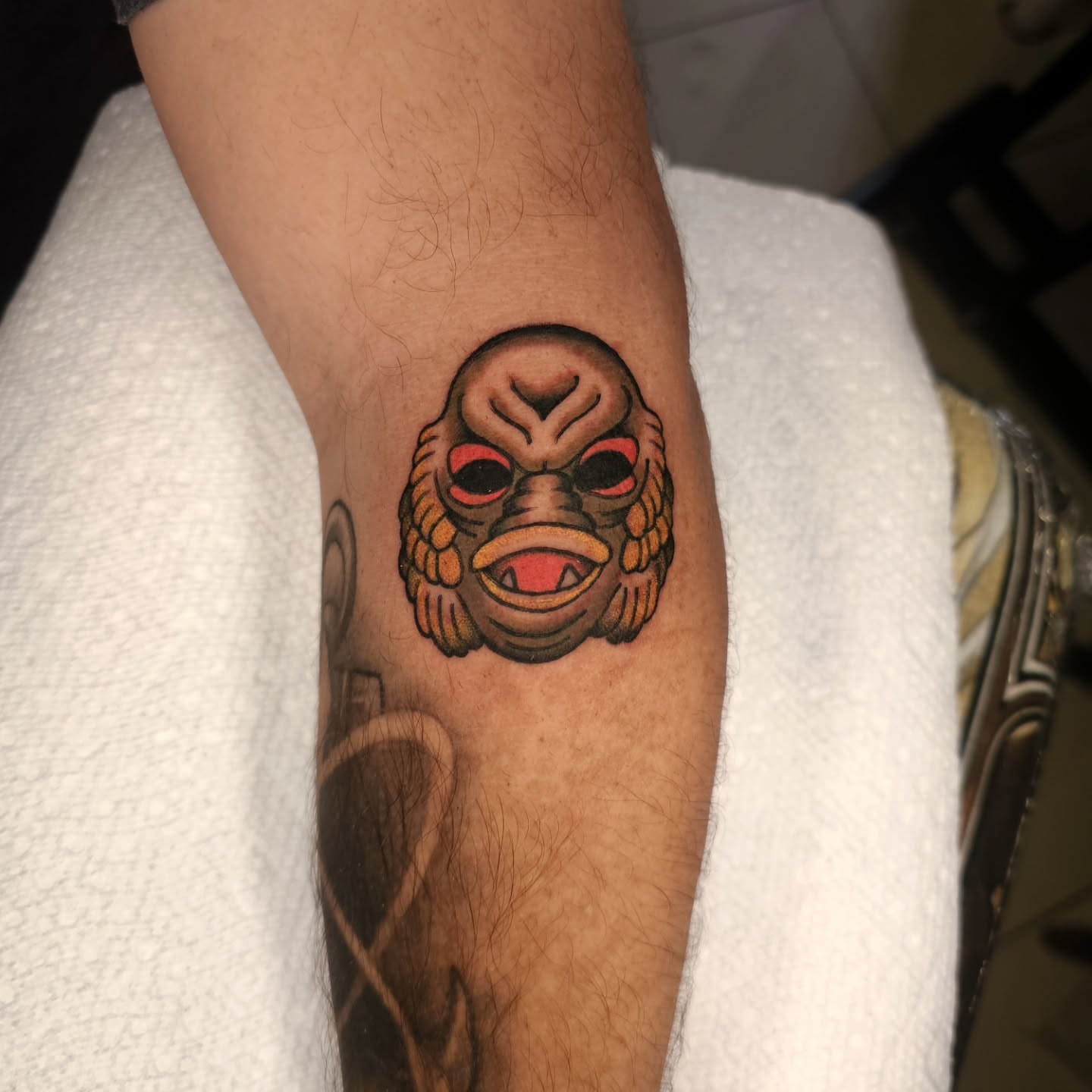 Mask American traditional tattoo on the forearm by Nathan Thomas