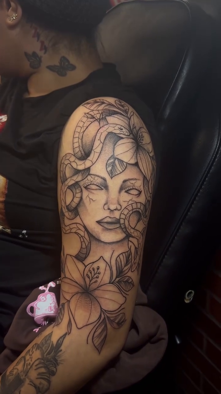 Medusa with snakes and flowers realism tattoo by Marvin Osorno