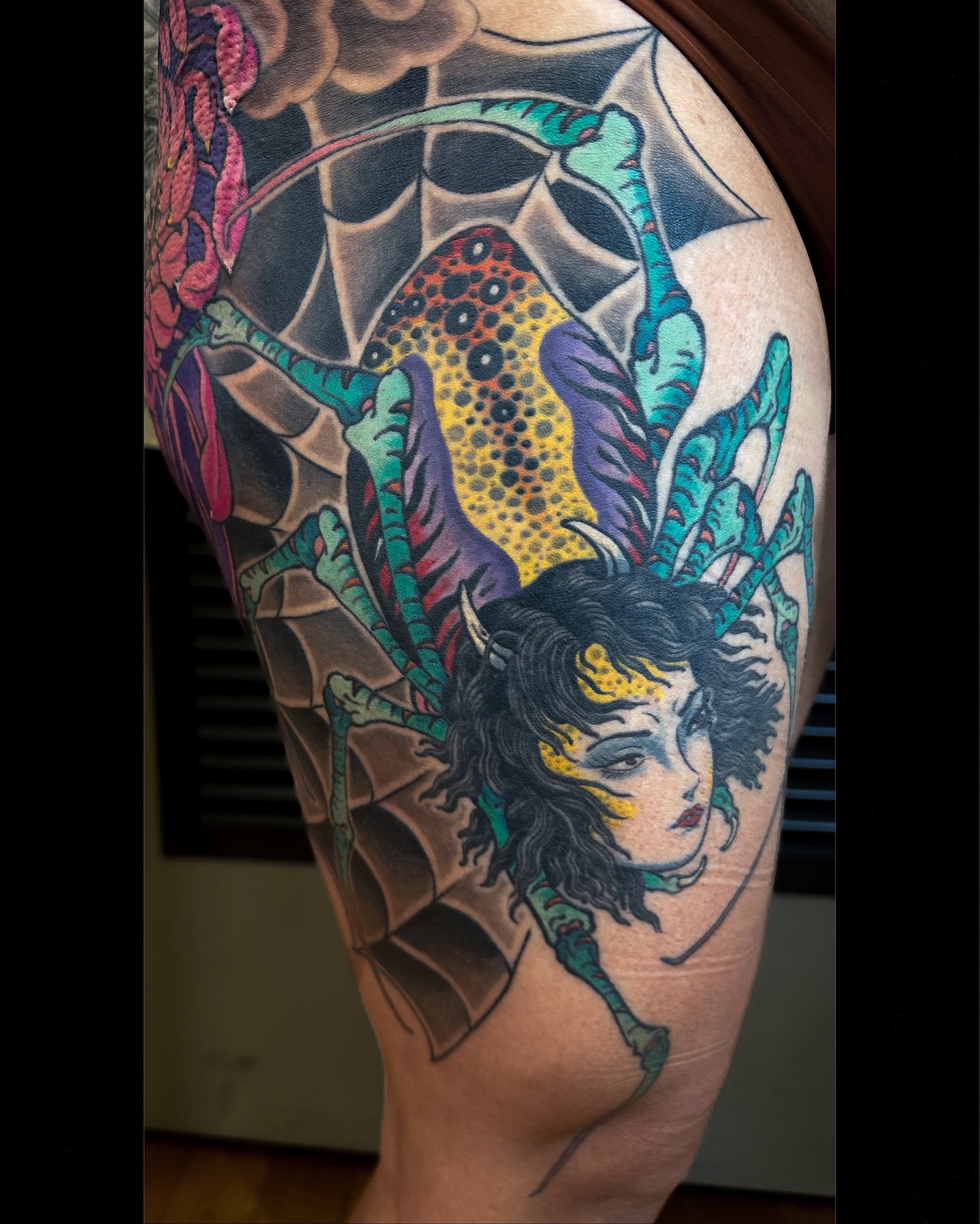 Woman with dragon wings dotwork tattoo on the upper arm by Colin Kenji Baker, San Jose, California