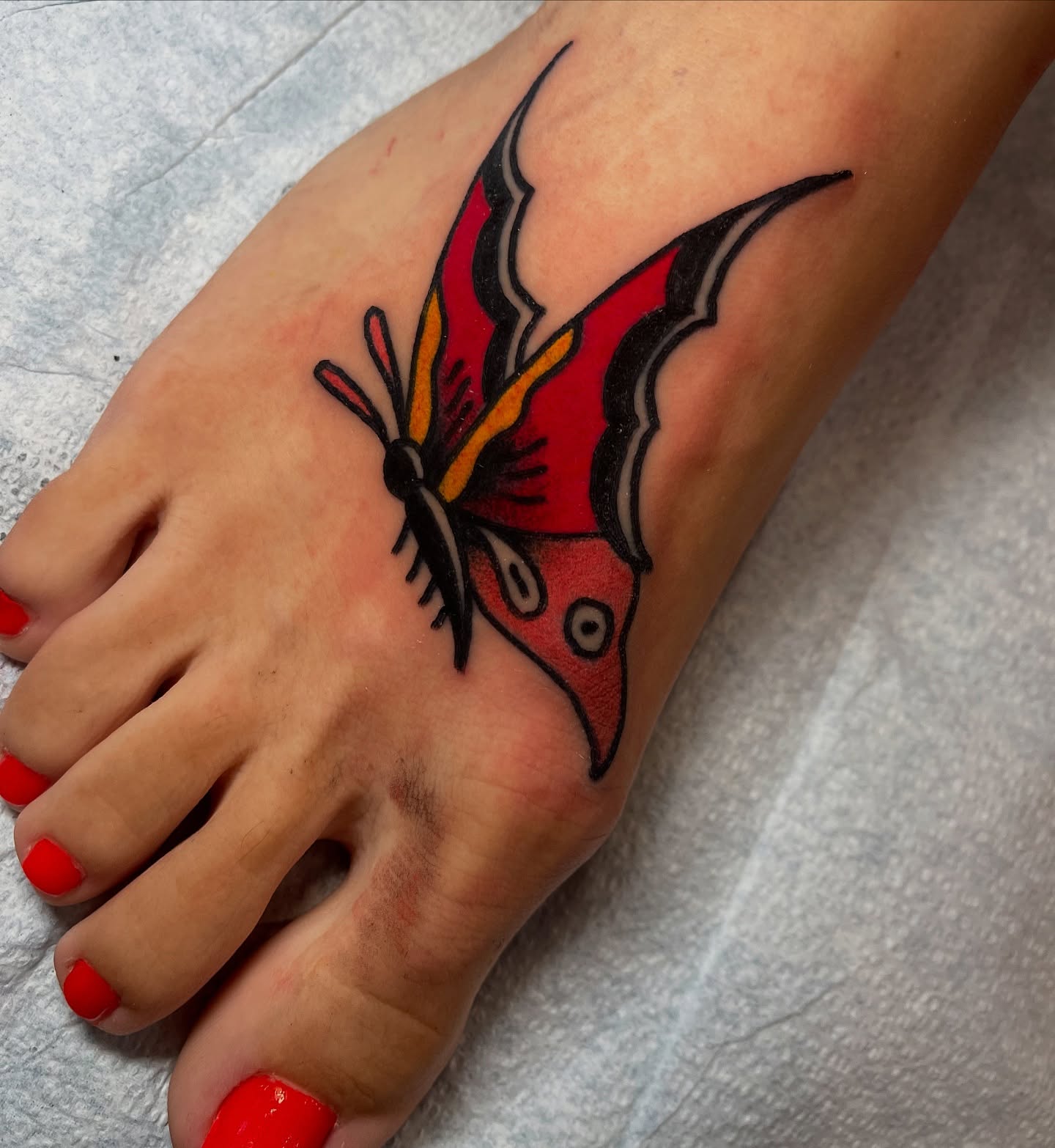 Butterfly American traditional tattoo on the foot by adamsayre, San Diego, California