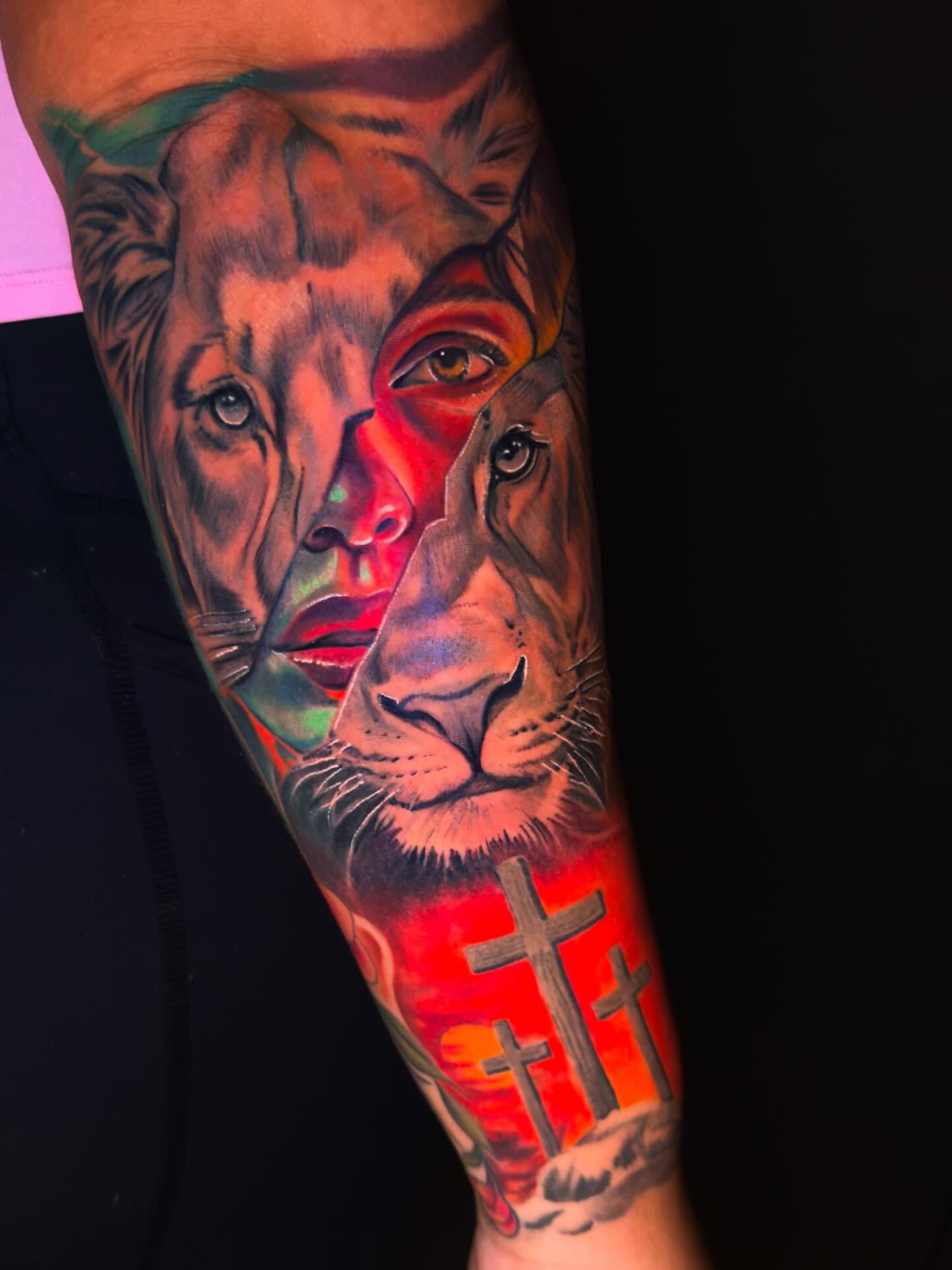 Lion and human face realism tattoo on the forearm by Eric Zuluaga