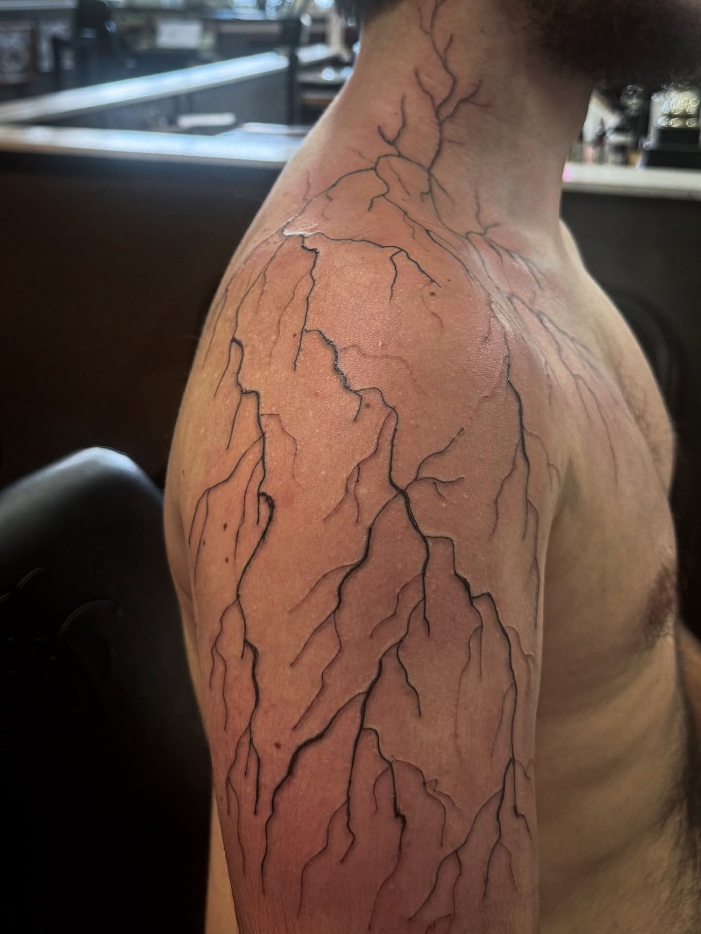 Crack pattern black and grey tattoo on the shoulder by Lexy