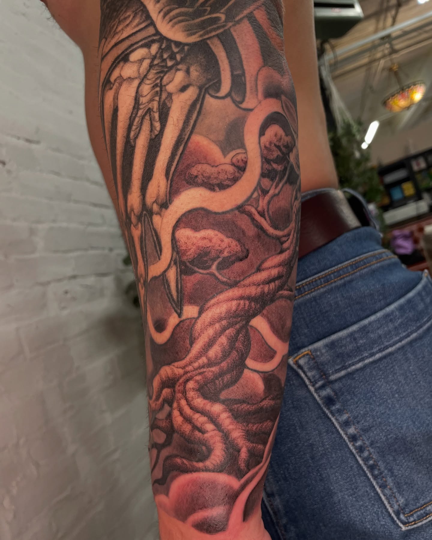 Serpent and skull realism tattoo on the forearm by Collie Mills, Philadelphia, Pennsylvania