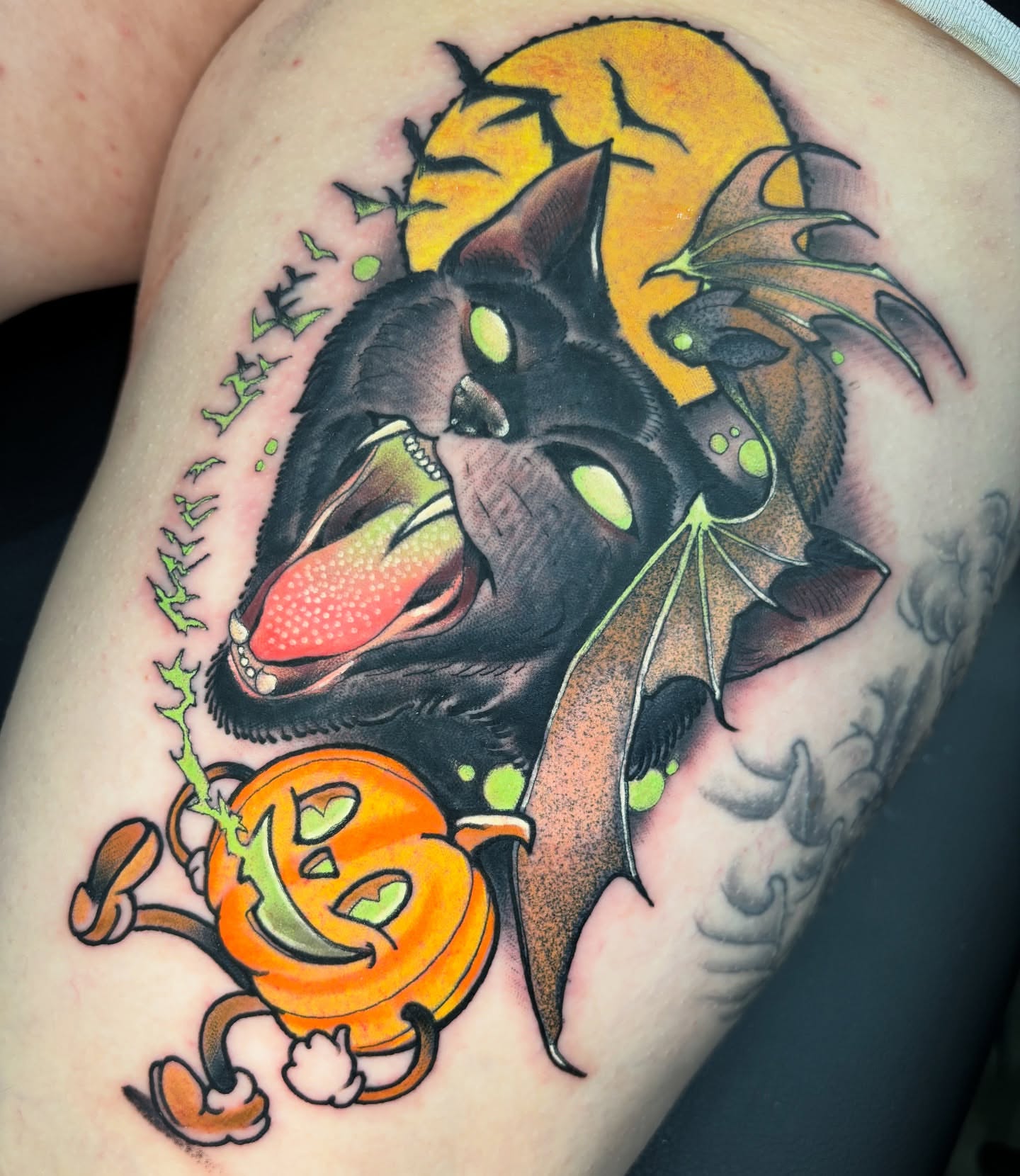 Bat and pumpkin American traditional tattoo on the thigh by Matt Stolzenburg