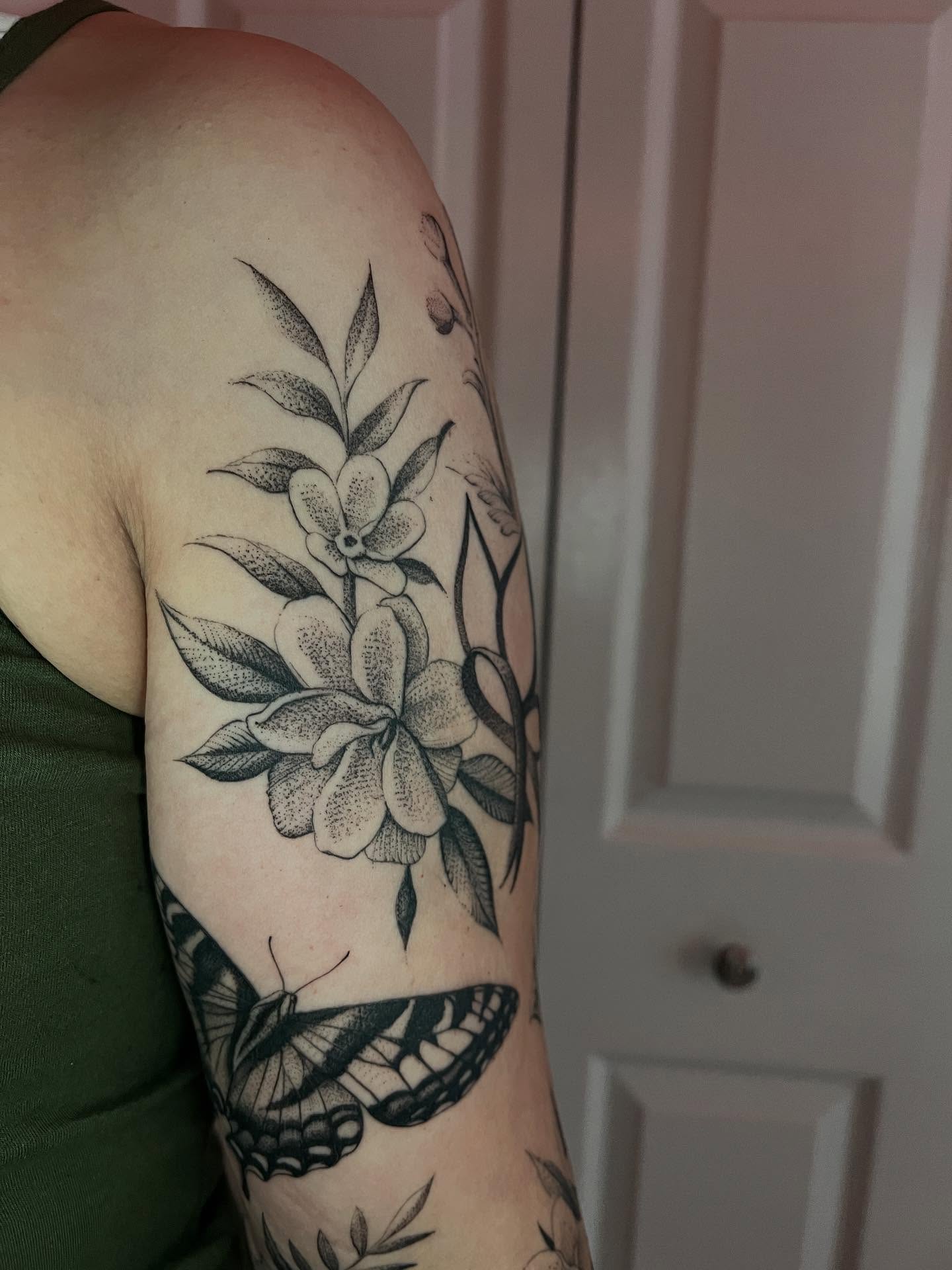 Flower and butterfly dotwork tattoo on the forearm by Natasha