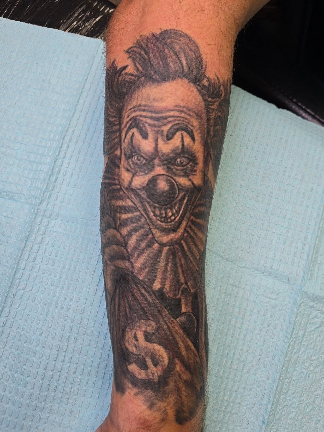 Clown realism tattoo on the forearm by Karen Cain