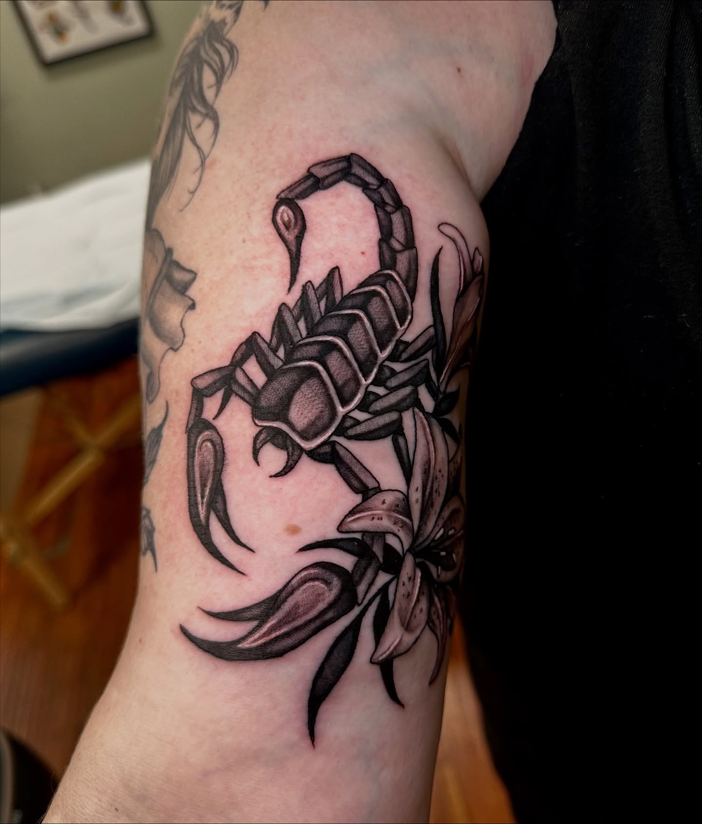 Scorpion and lily realism tattoo on the forearm by Marisa Biddle