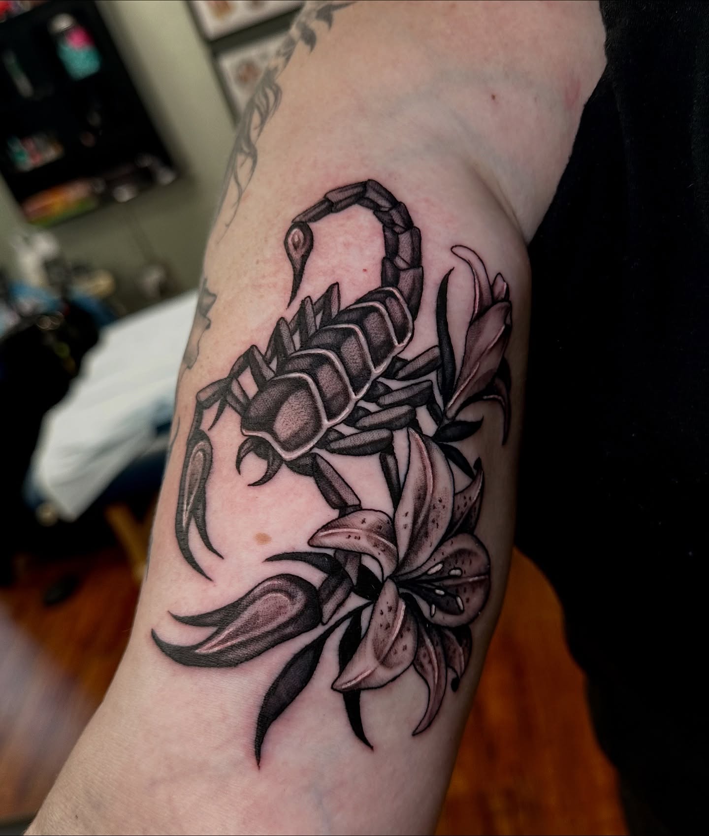 Scorpion and lilies realism tattoo on the forearm by Marisa Biddle