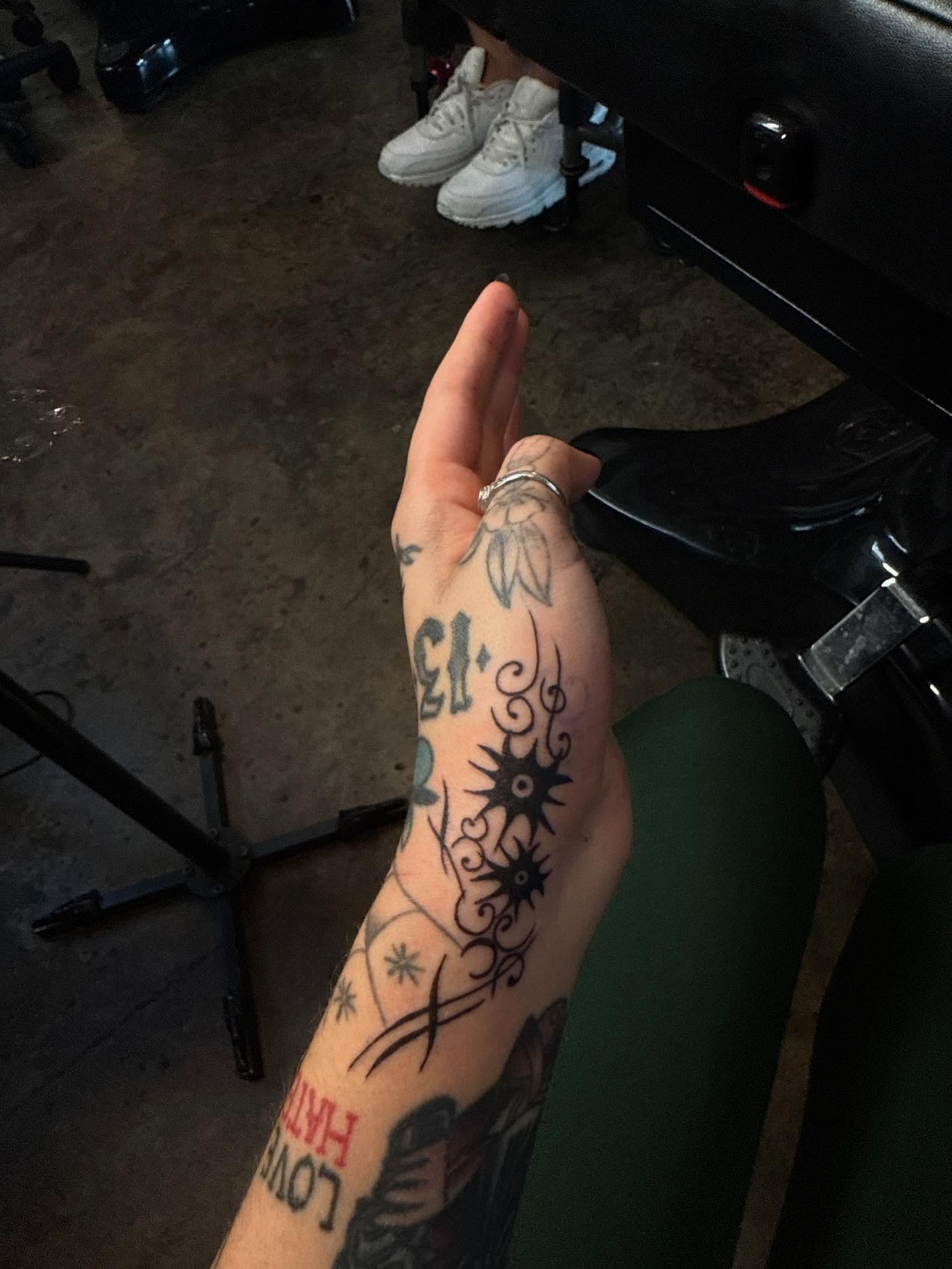 Floral and sun design American traditional tattoo on the forearm by frankie quadrini