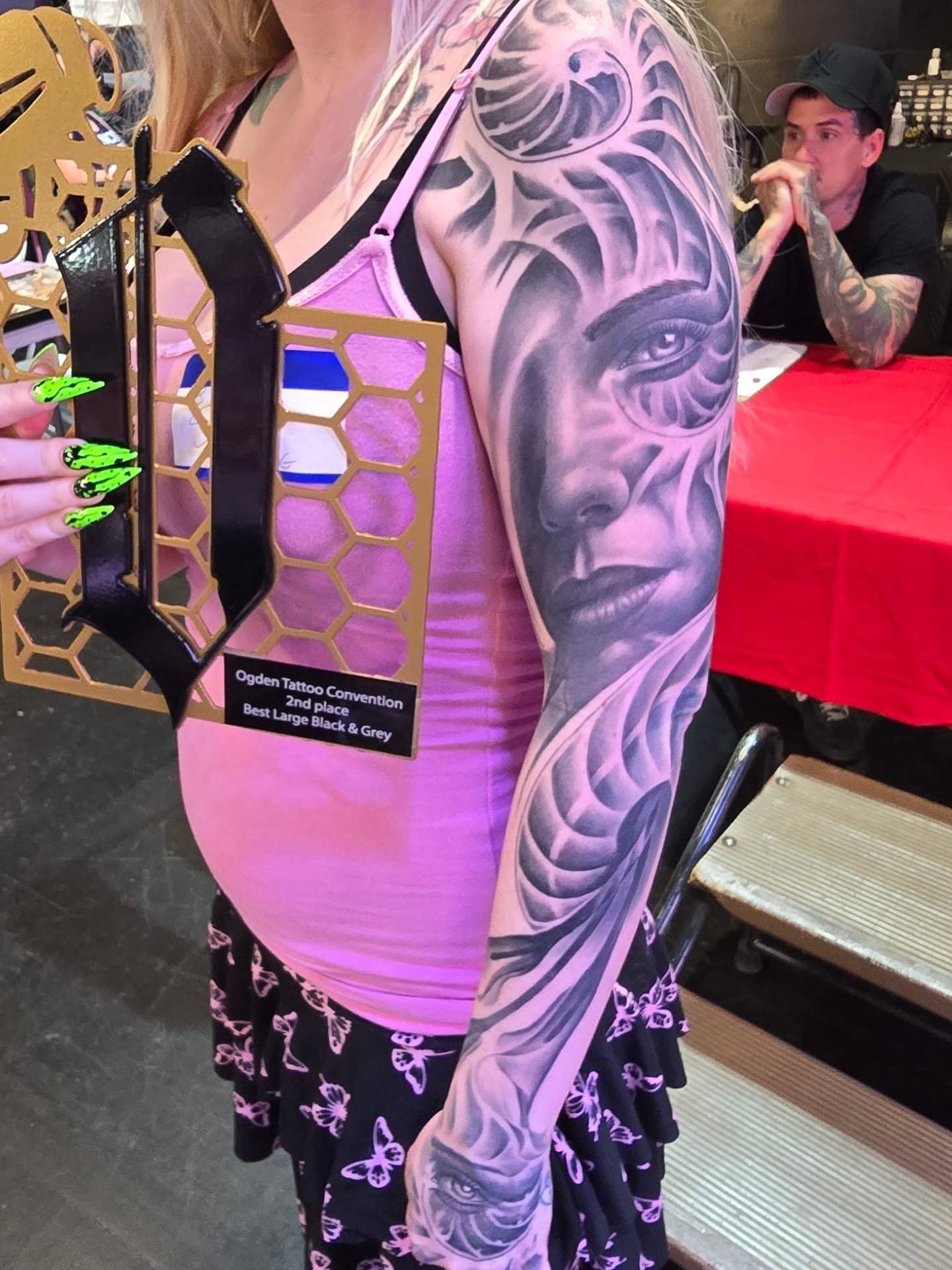Female face realism tattoo on the upper arm by Jack Daniel Knowlden