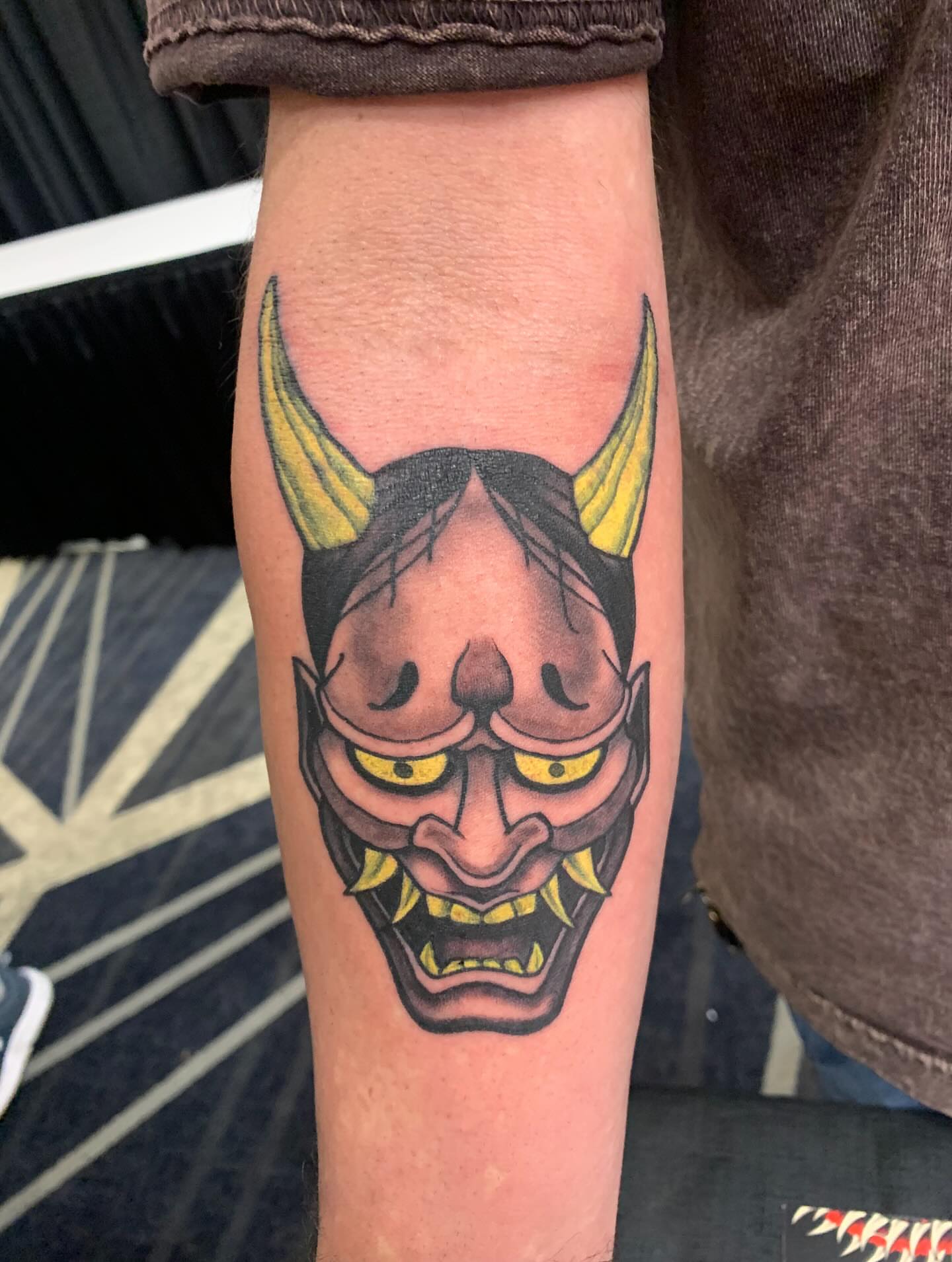 Demon mask American traditional tattoo on the forearm by Devon