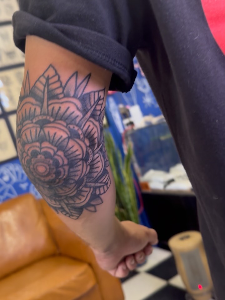 Floral design black and grey tattoo on the forearm by Don Robison