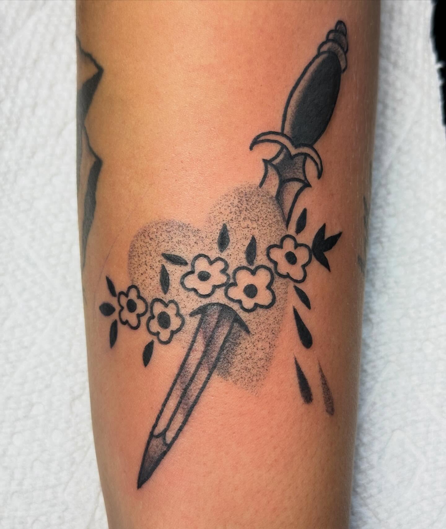 Knife and flowers dotwork tattoo on the forearm by Eli