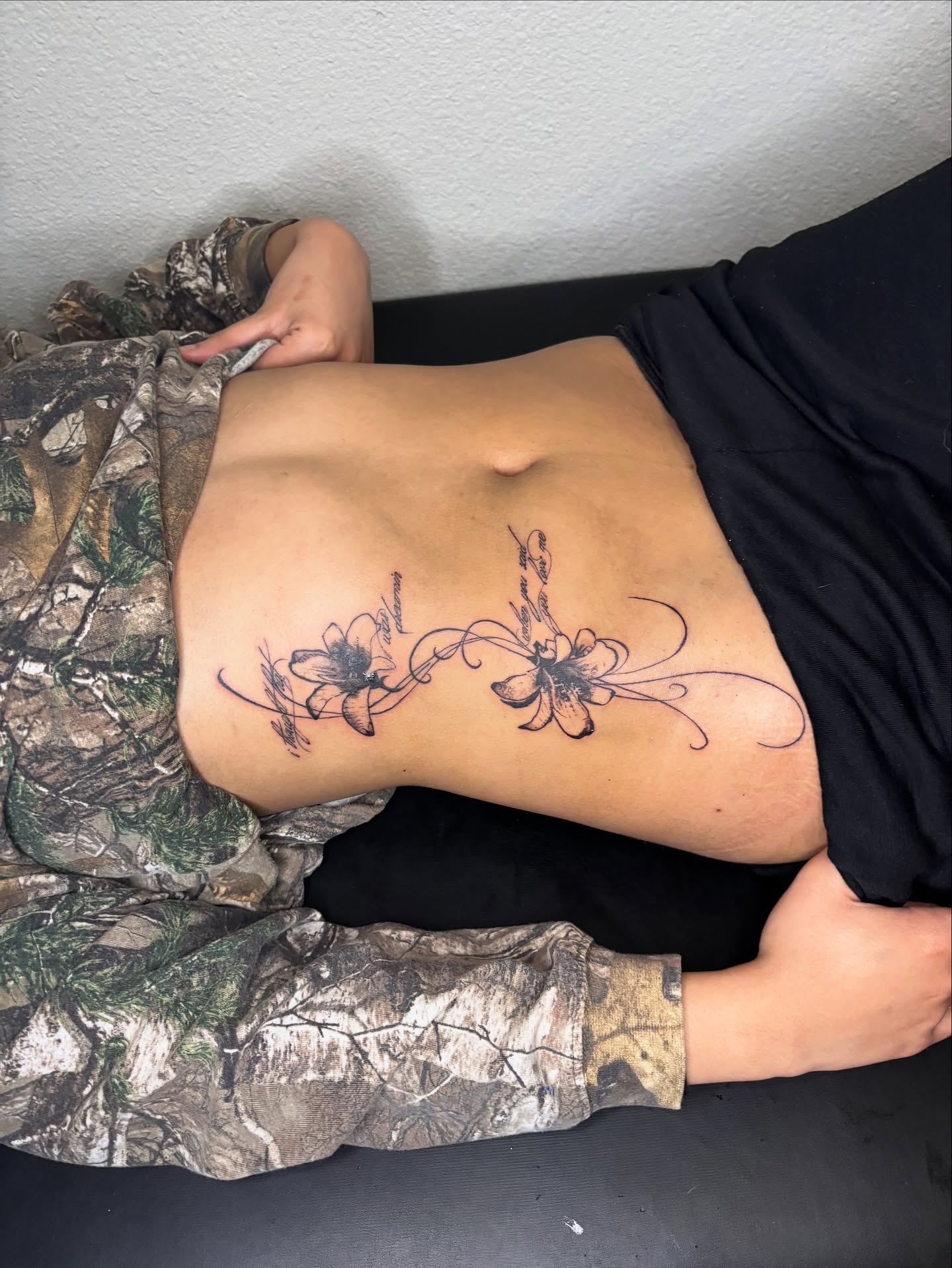 Flowers black and grey tattoo on the back by @miffythereaper