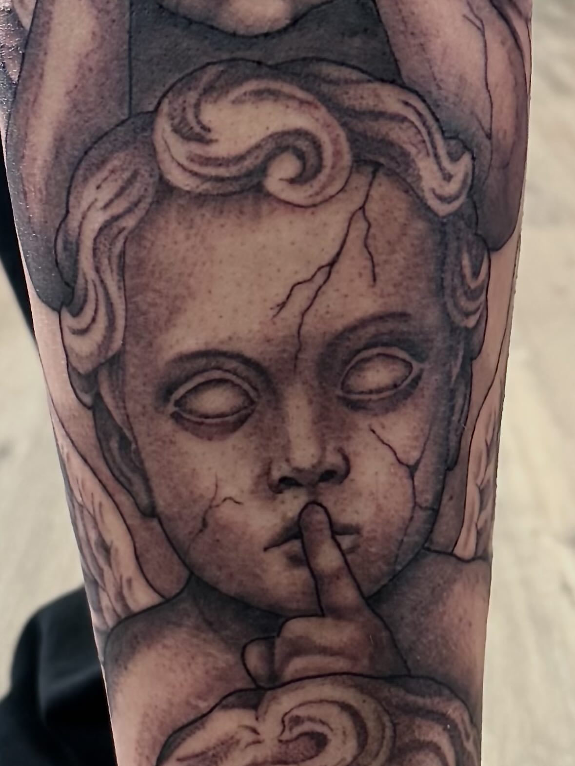Angel realism tattoo on the forearm by Robbie Bryant