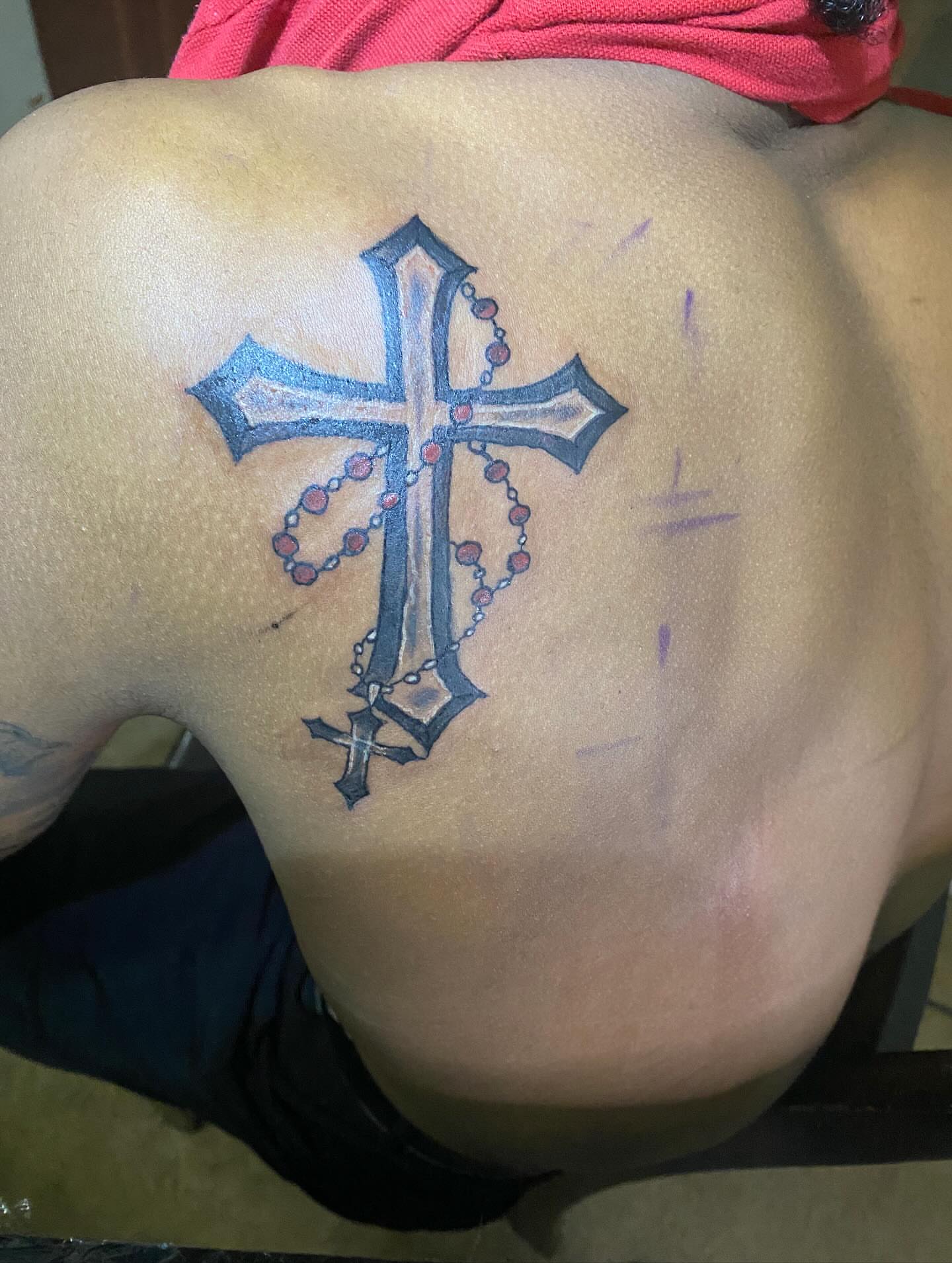 Cross with rosary American traditional tattoo on the back by Illuminink.gallery