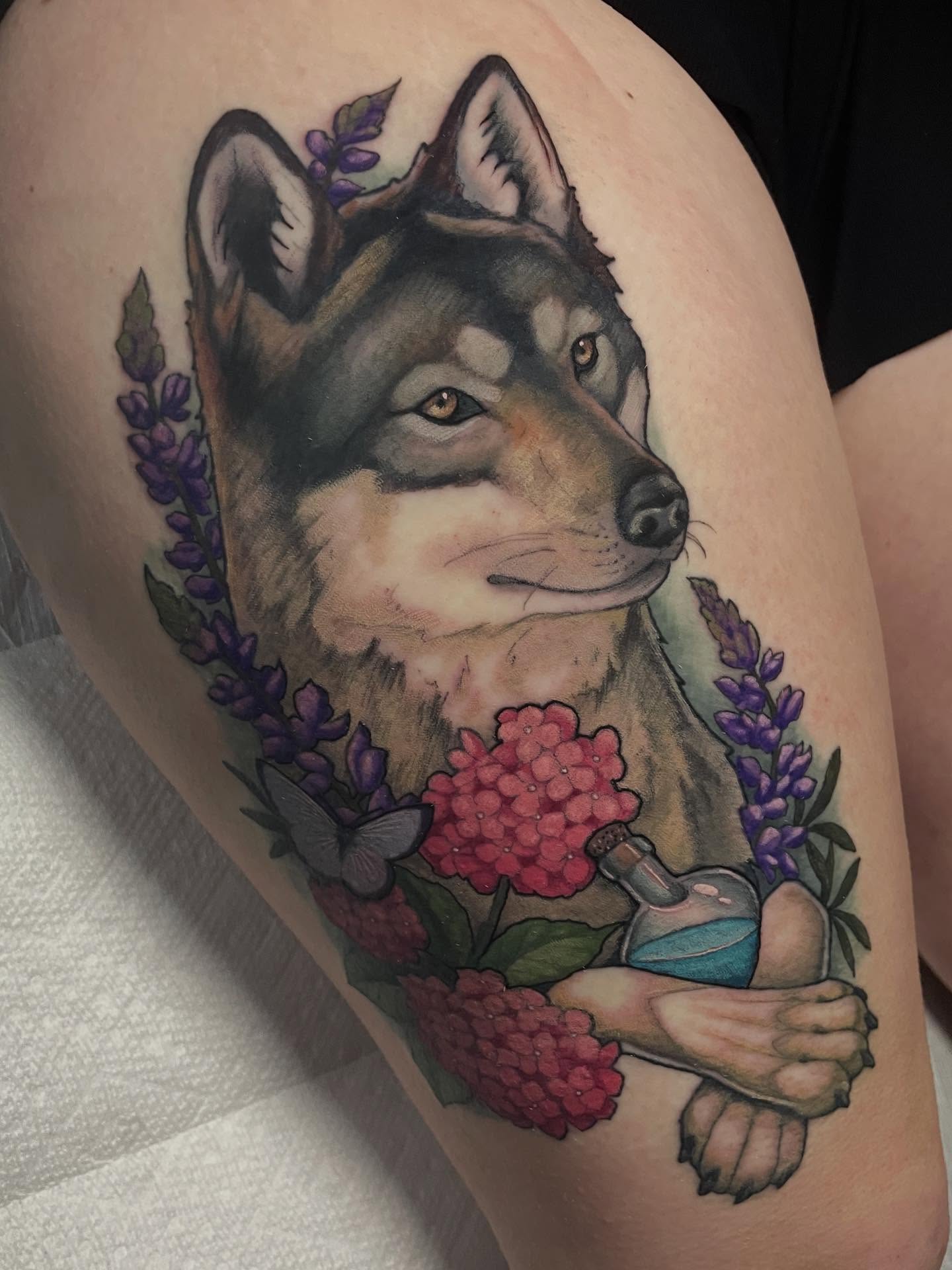 Wolf with flowers realism tattoo on the thigh by Leah Marie, Cincinnati