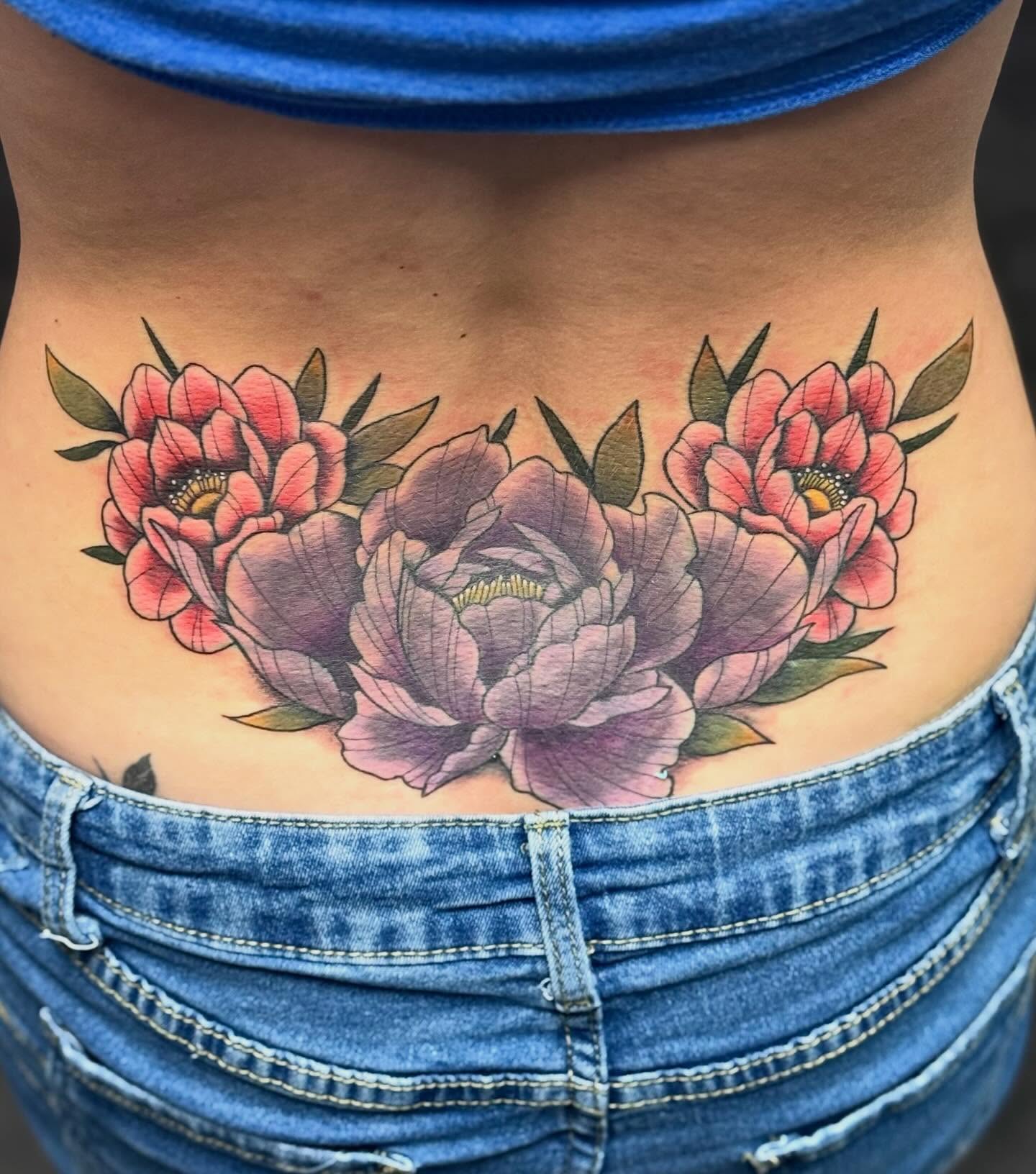 Peonies realism tattoo on the torso by @carissaetattoos