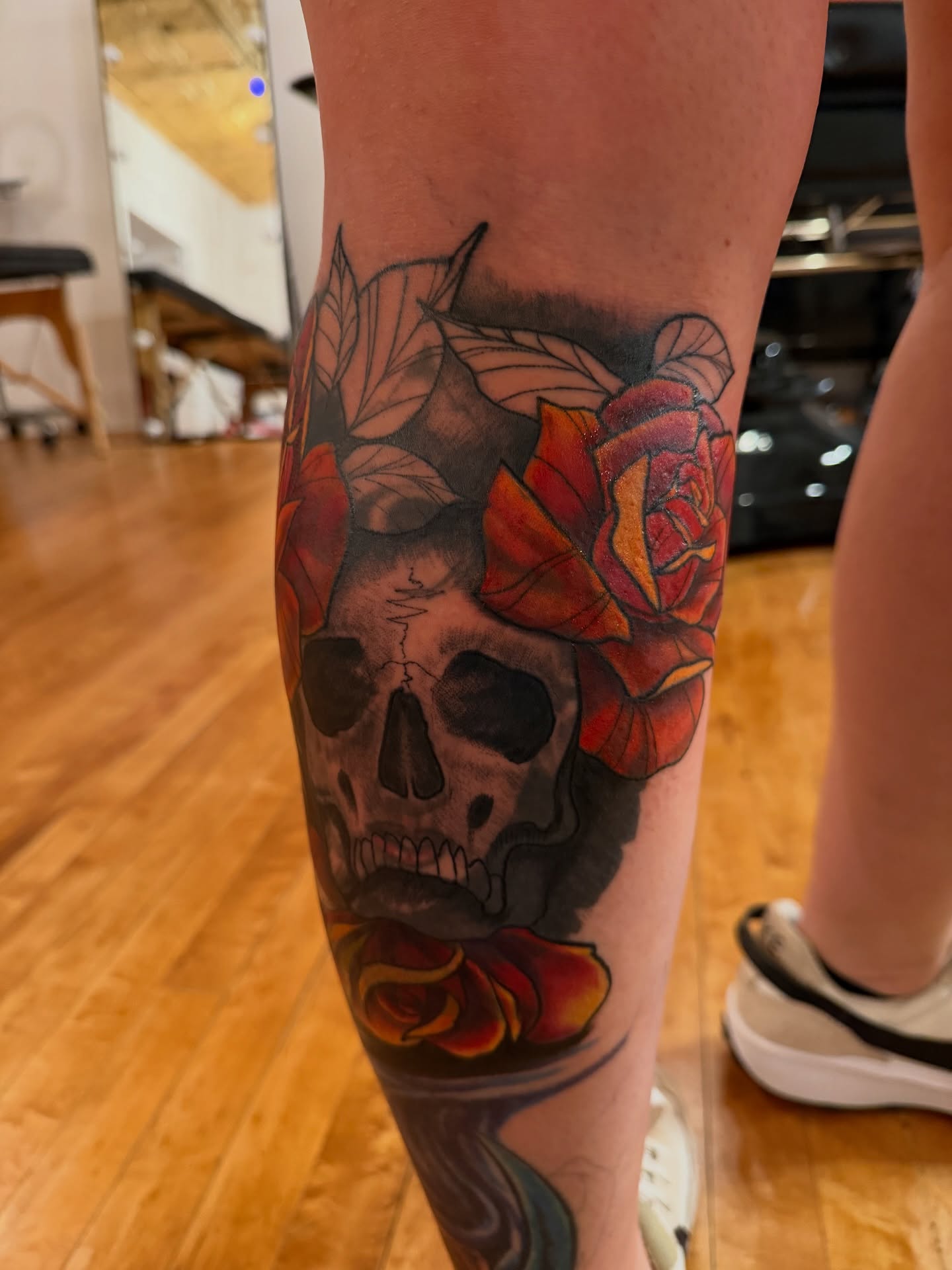 Skull with roses American traditional tattoo on the forearm by steven