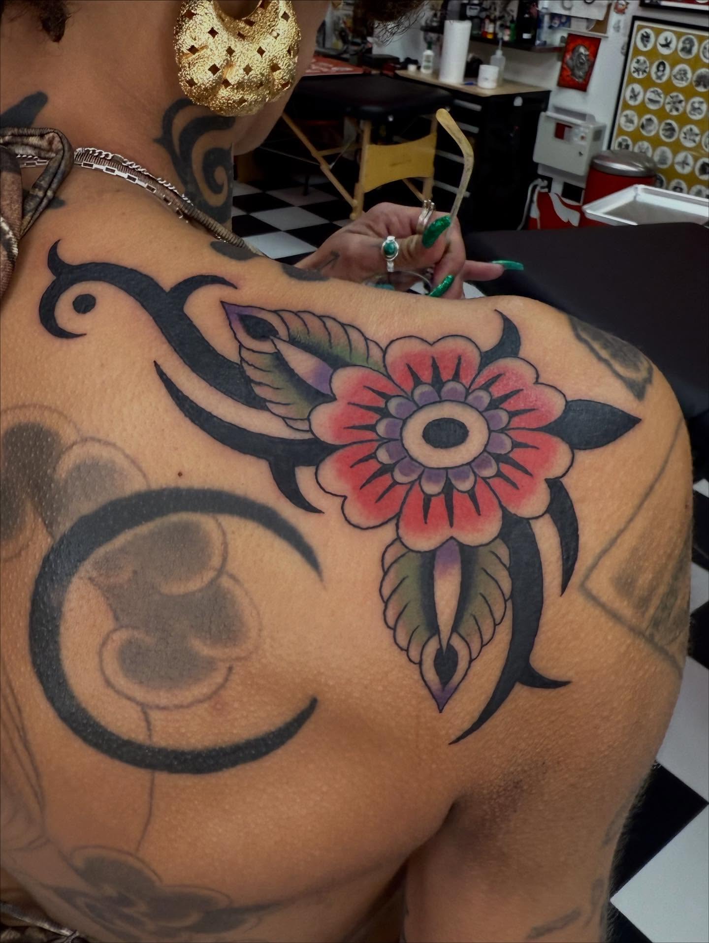 Flower with tribal elements American traditional tattoo on the shoulder by Emma Eaton