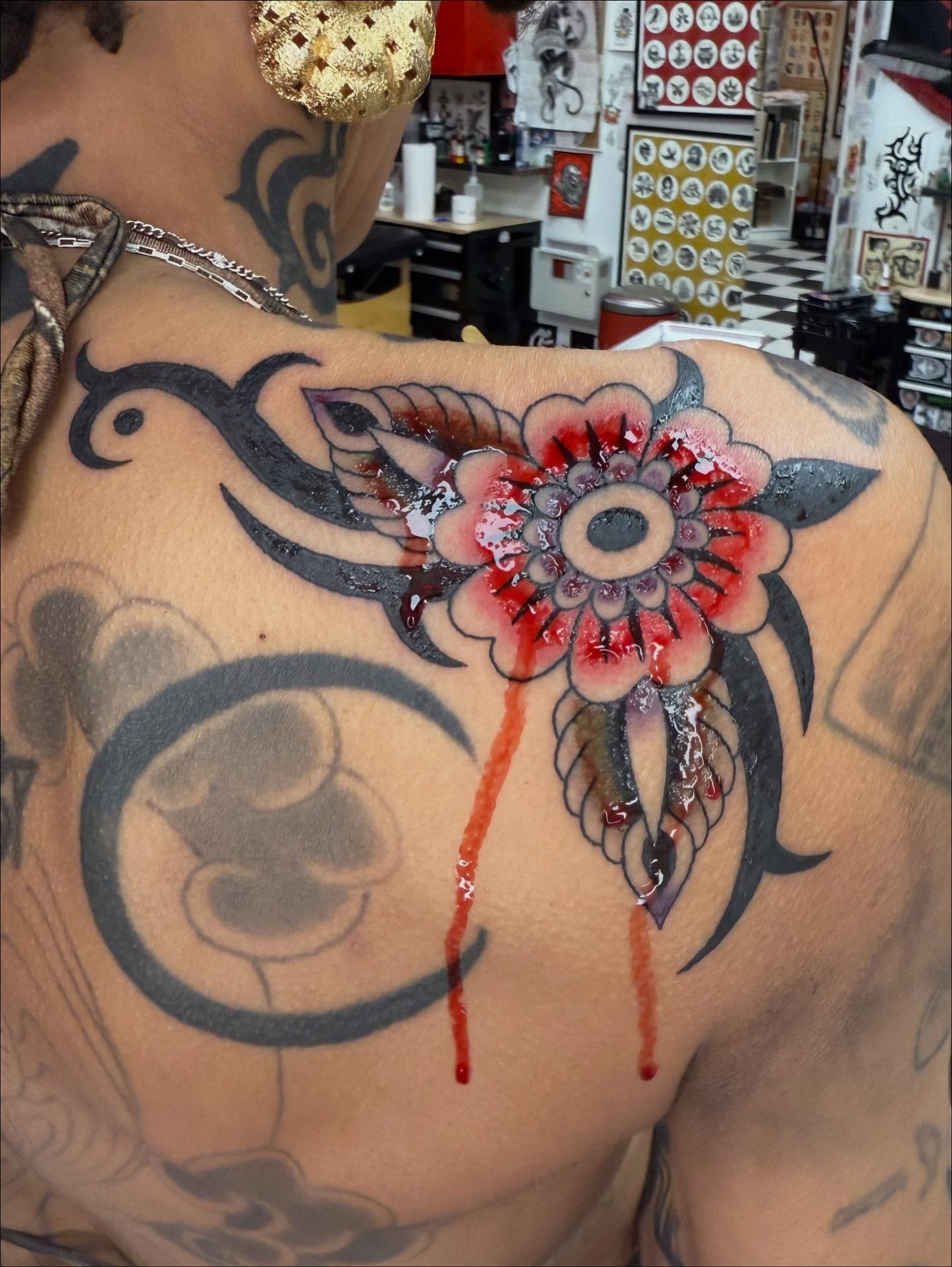 Flower American traditional tattoo on the shoulder by Emma Eaton