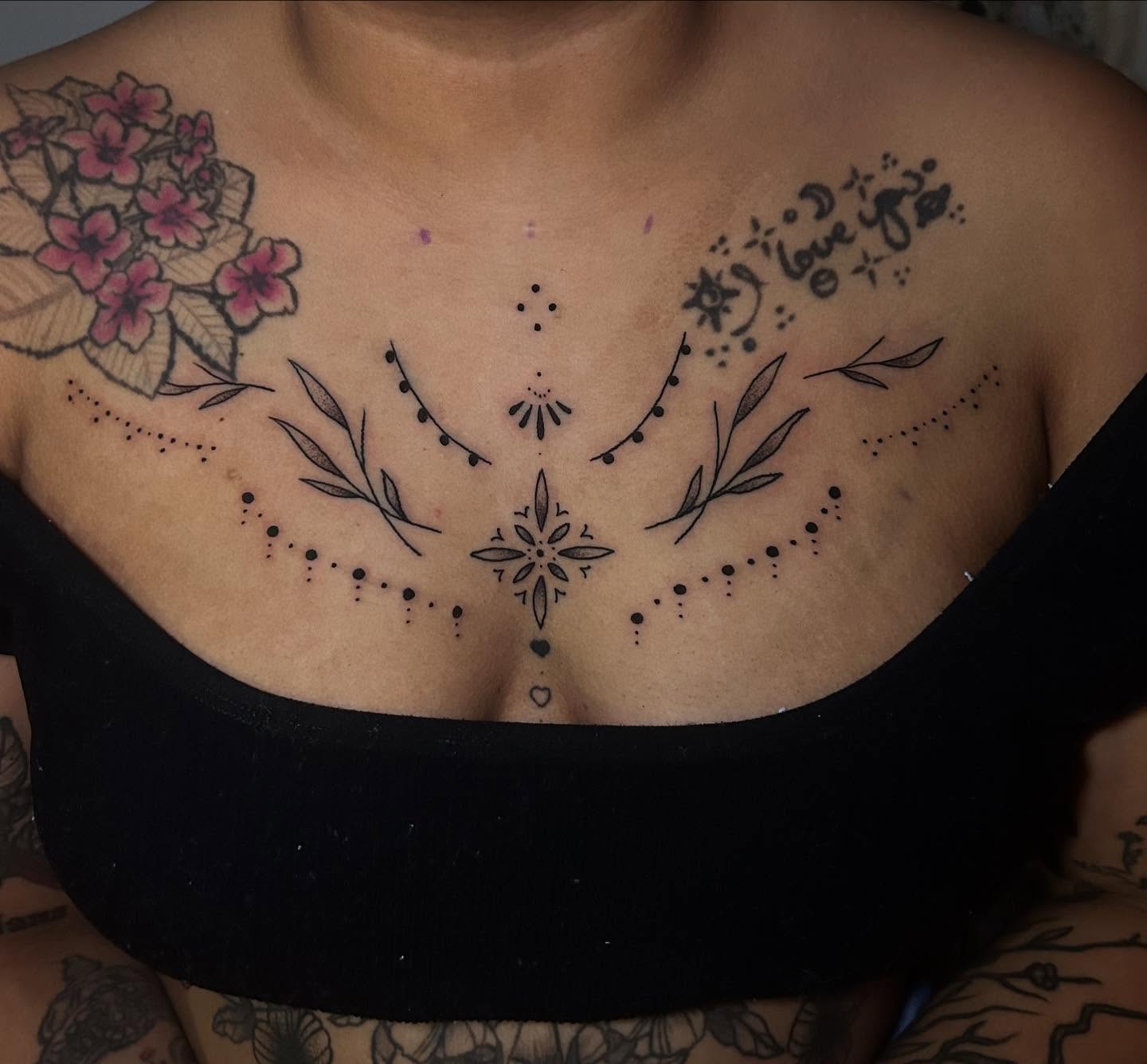 Floral and geometric design dotwork tattoo on the chest by Maggie
