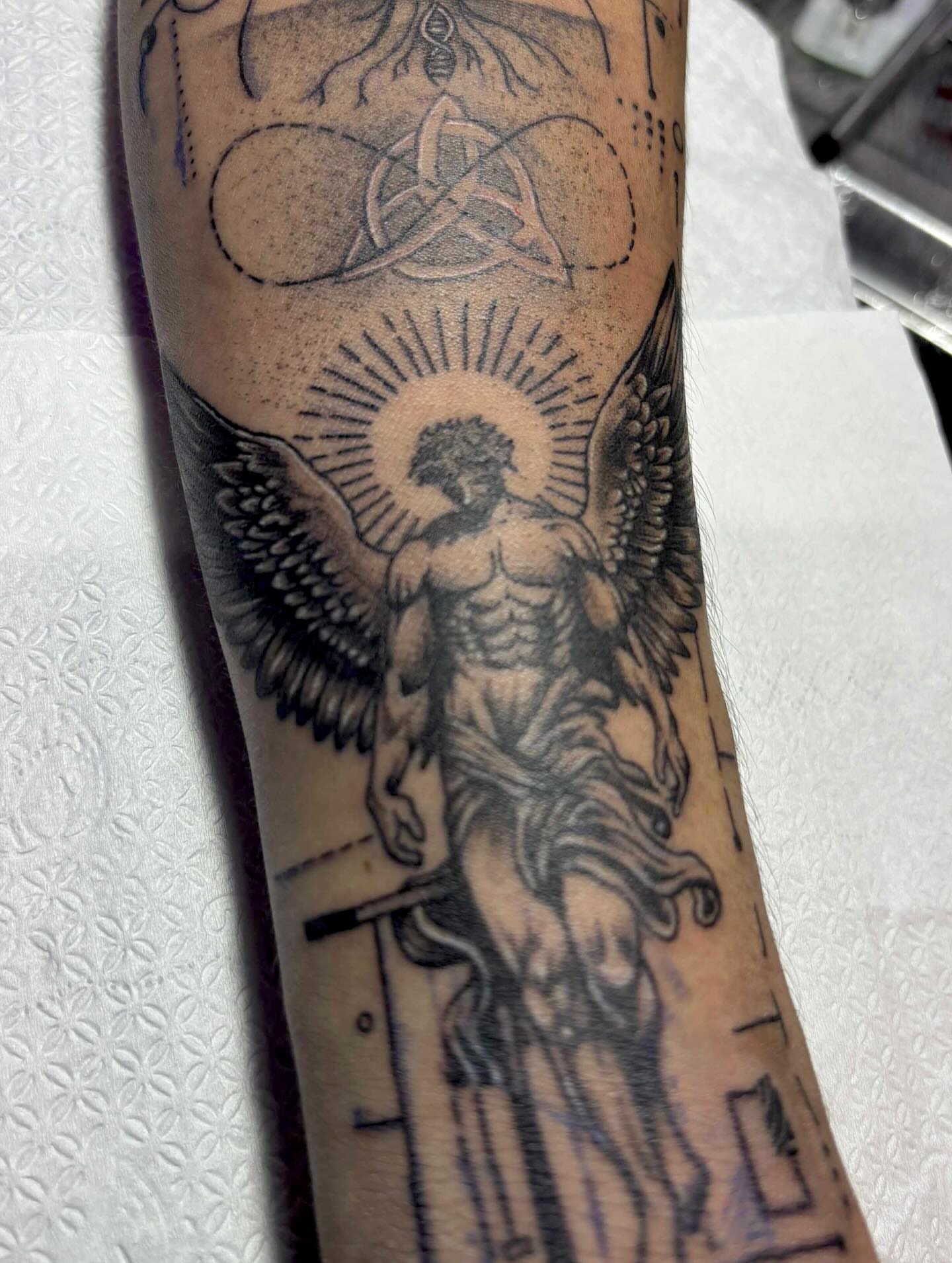 Angel with halo American traditional tattoo on the forearm by Gerd thINK_TATTOO