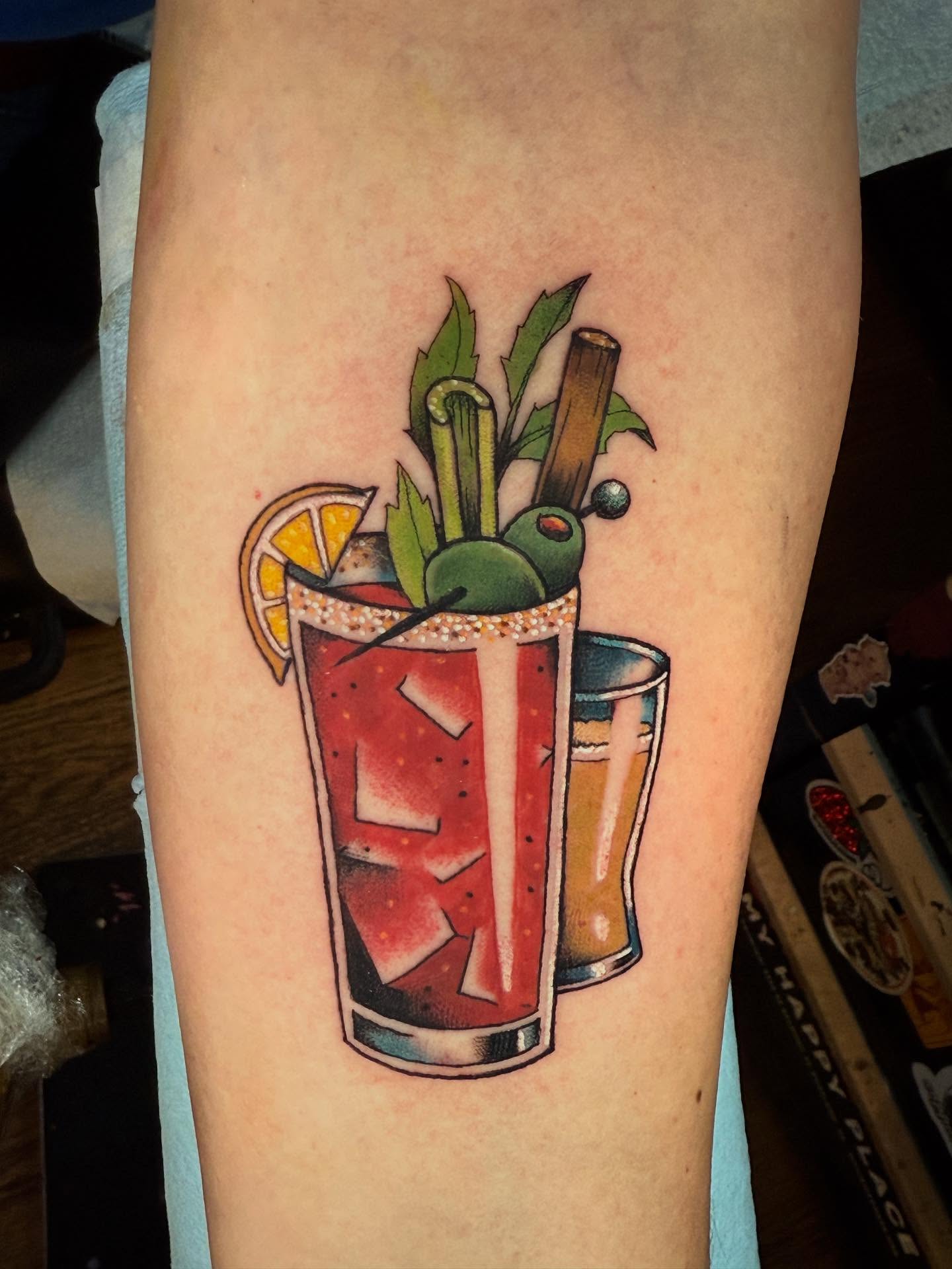 Martini new school tattoo on the forearm by Katy Bisby