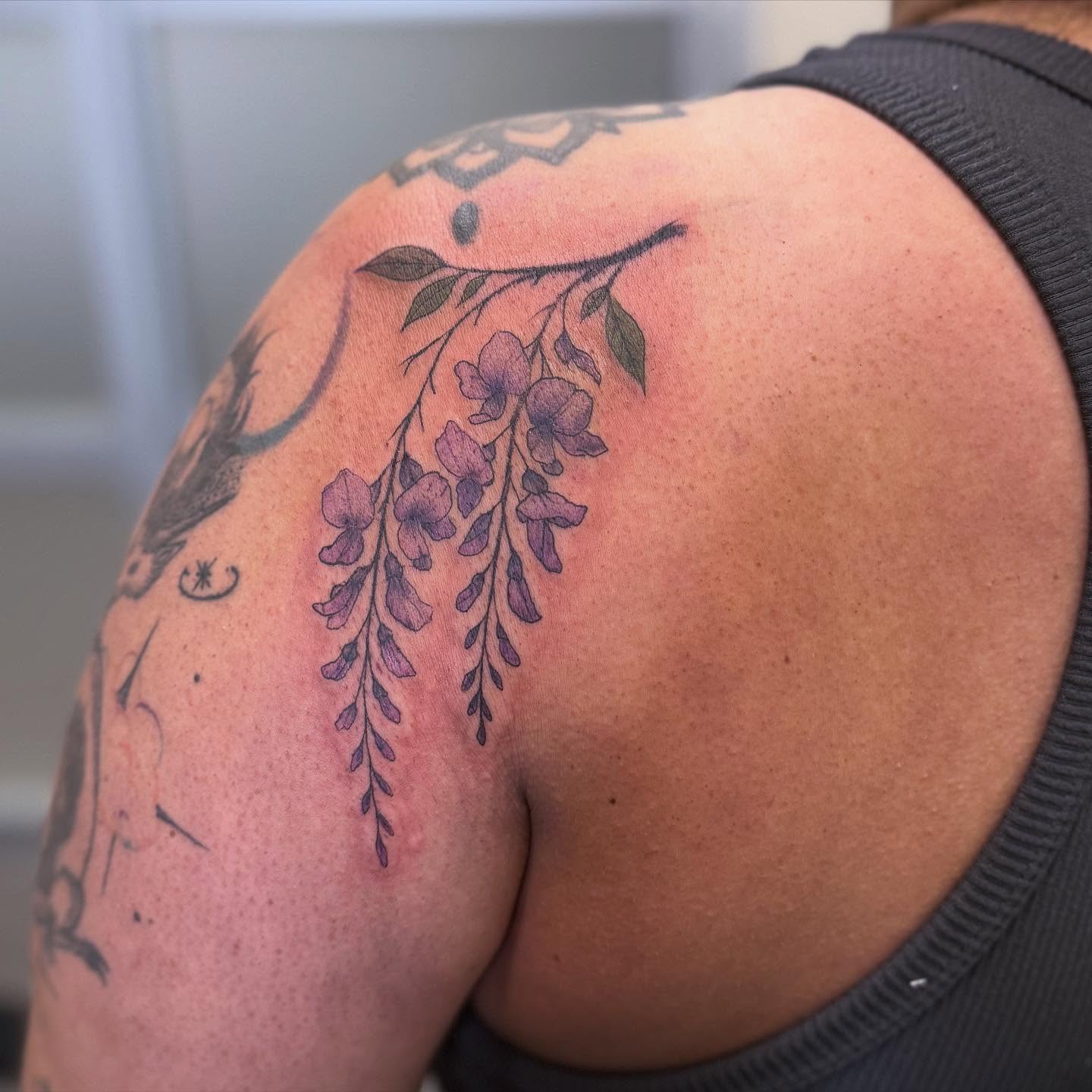 Wisteria flowers dotwork tattoo on the shoulder by Gladys L.