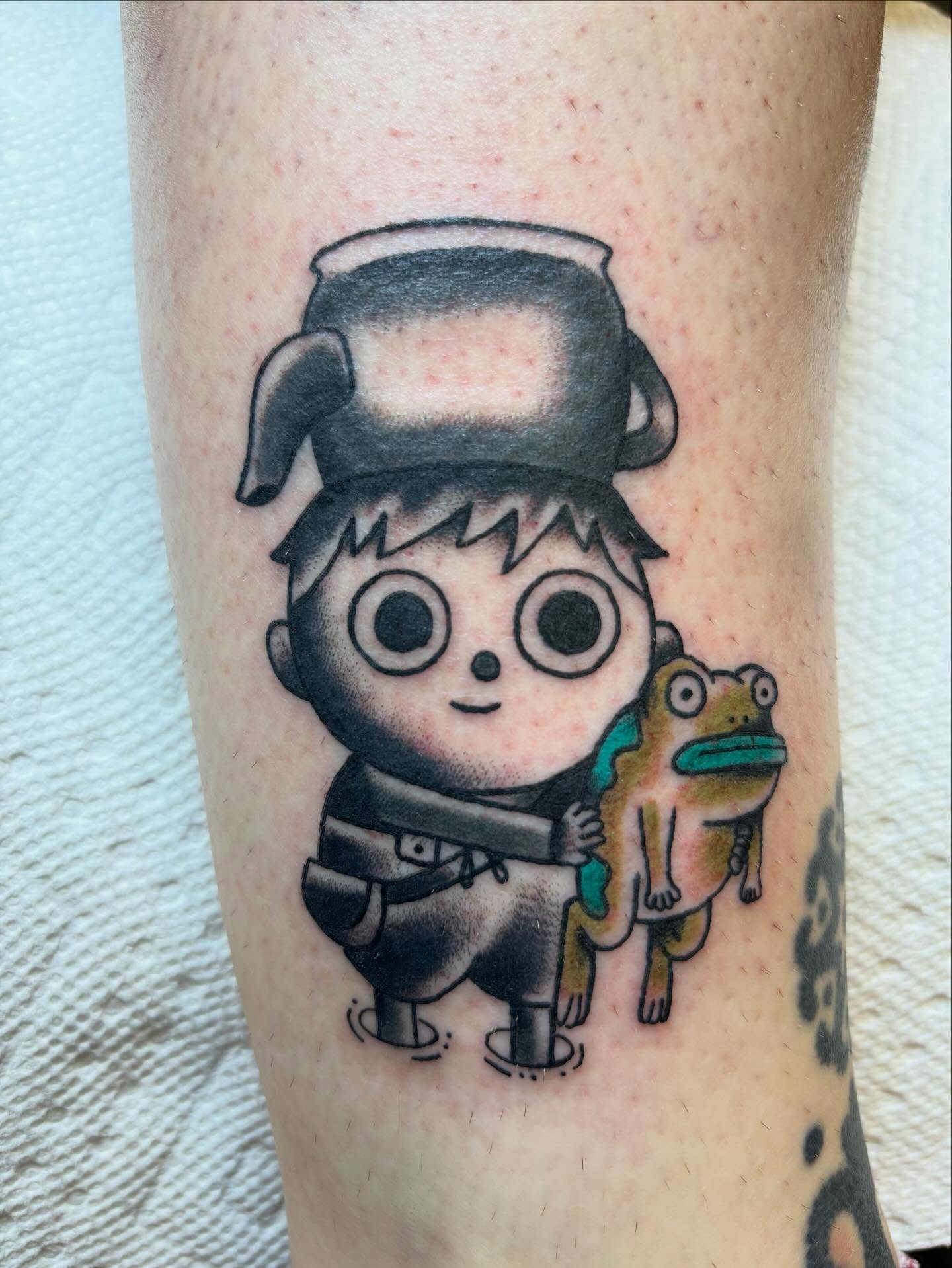 Boy with frog black and grey tattoo on the forearm by Ben Whyte