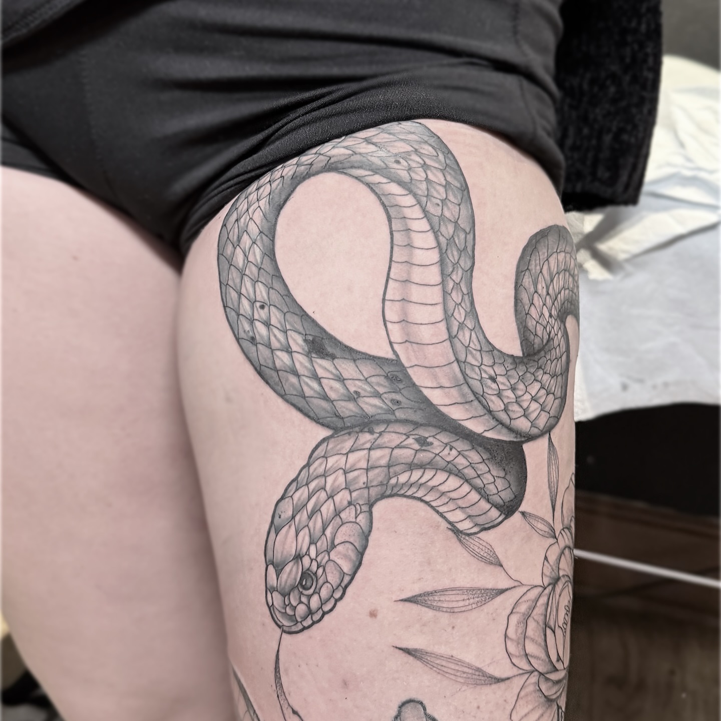 Snake black and grey tattoo on the thigh by Rafael Alfredo Armas Hoyos, Salt Lake City, Utah