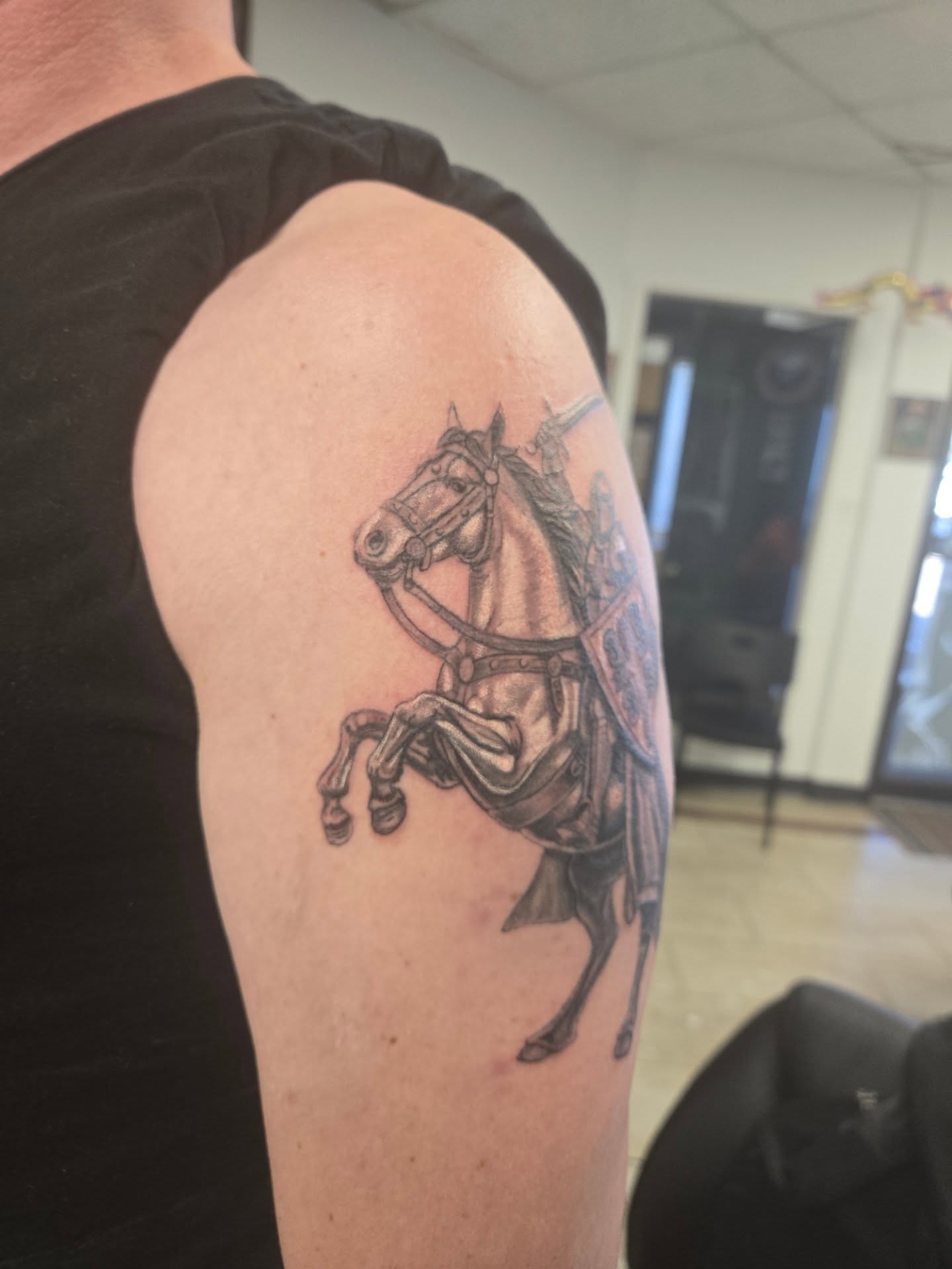 Horse and rider black and grey tattoo on the shoulder by Jose G. Rubio Tattoo Artist πΊπ²ππ¨π¦