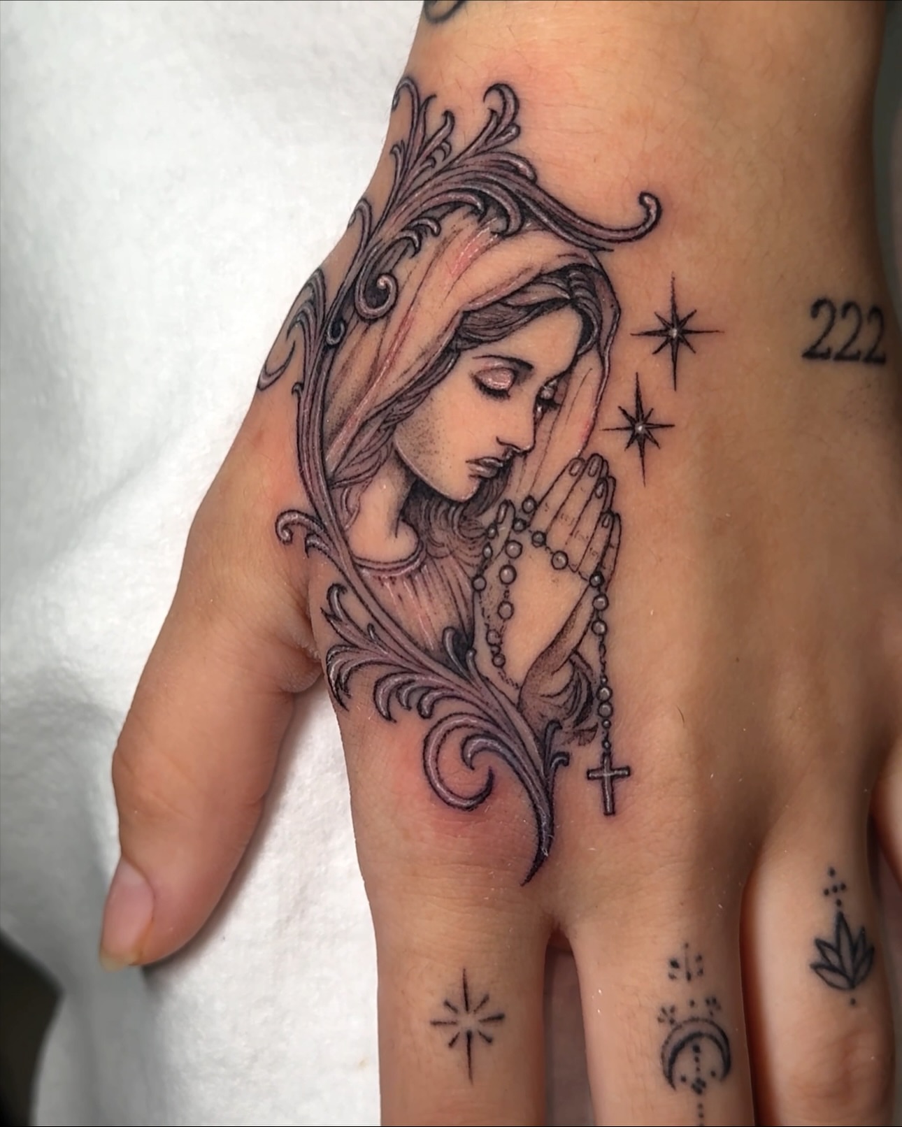 Praying woman realism tattoo on the hand by Eyekonic Ink