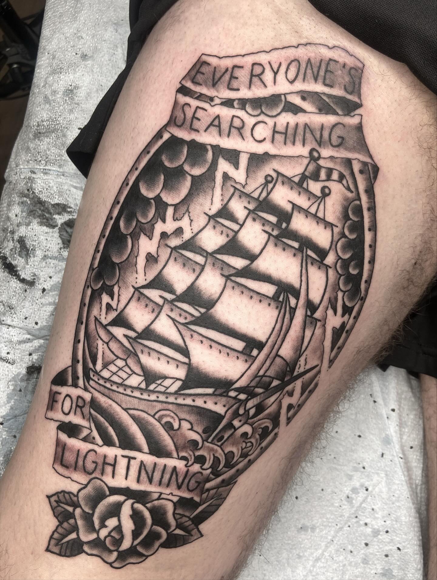 Ship and banner American traditional tattoo on the thigh by nicholas mcevoy, Boston, Massachusetts